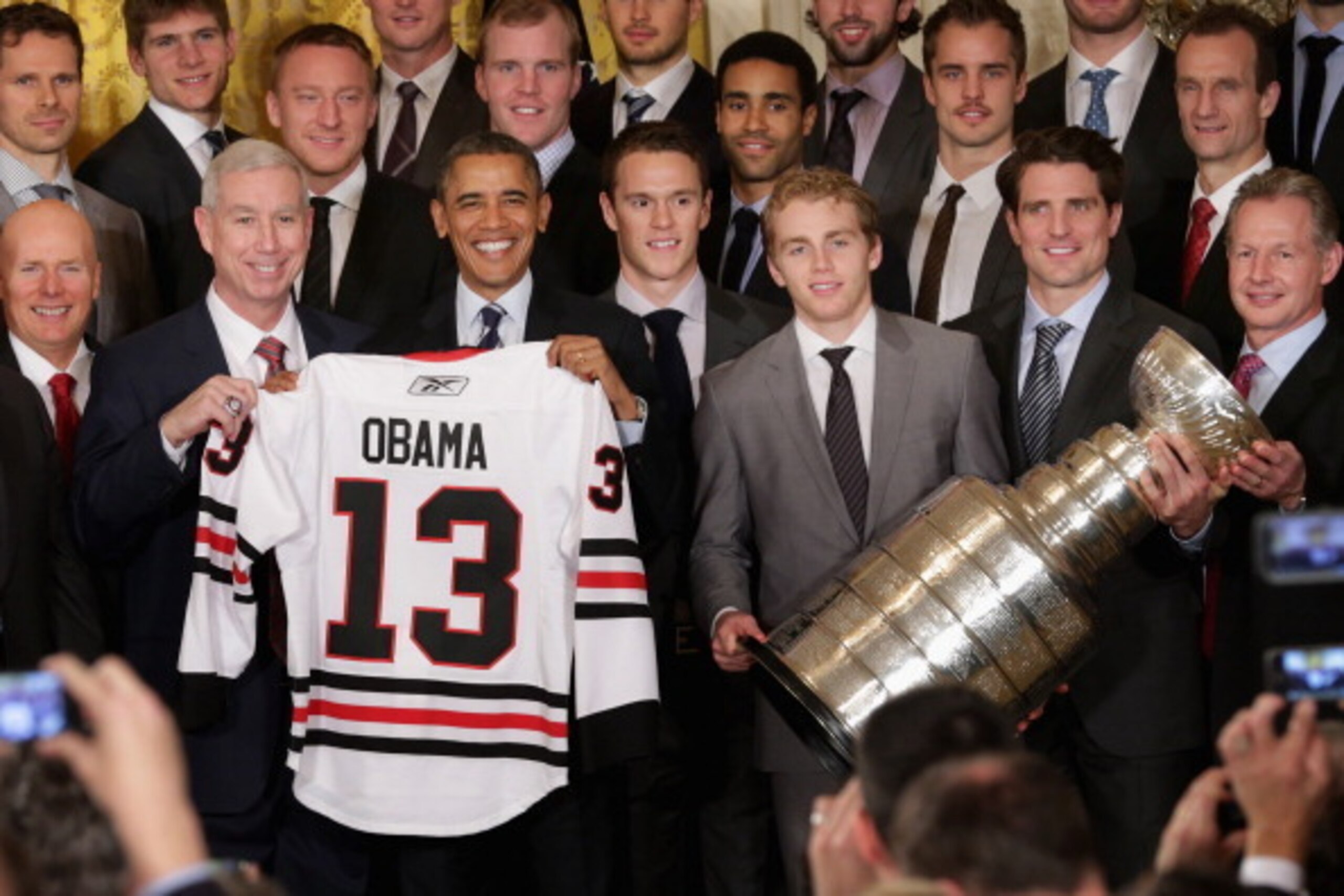 WASHINGTON, DC - NOVEMBER 04:  U.S. President Barack Obama (3rd L front row) poses for photographs with the National Hockey League 2013 champion Chicago Blackhawks (front row L-R) Executive Vice President Jay Blunk, President and CEO John McDonough, forwa