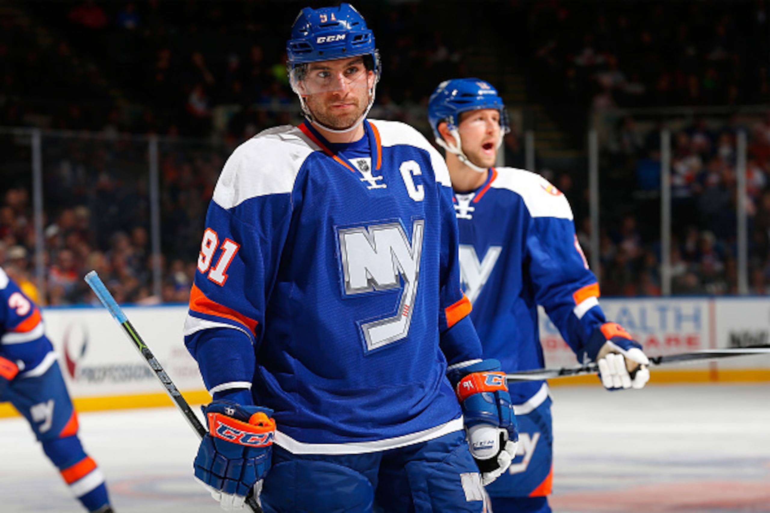 UNIONDALE, NY - FEBRUARY 22:  John Tavares #91 of the New York Islanders skates against the Vancouver Canucks at Nassau Veterans Memorial Coliseum on February 22, 2015 in Uniondale, New York. The Canucks defeated the Islanders 4-0.  (Photo by Mike Stobe/N