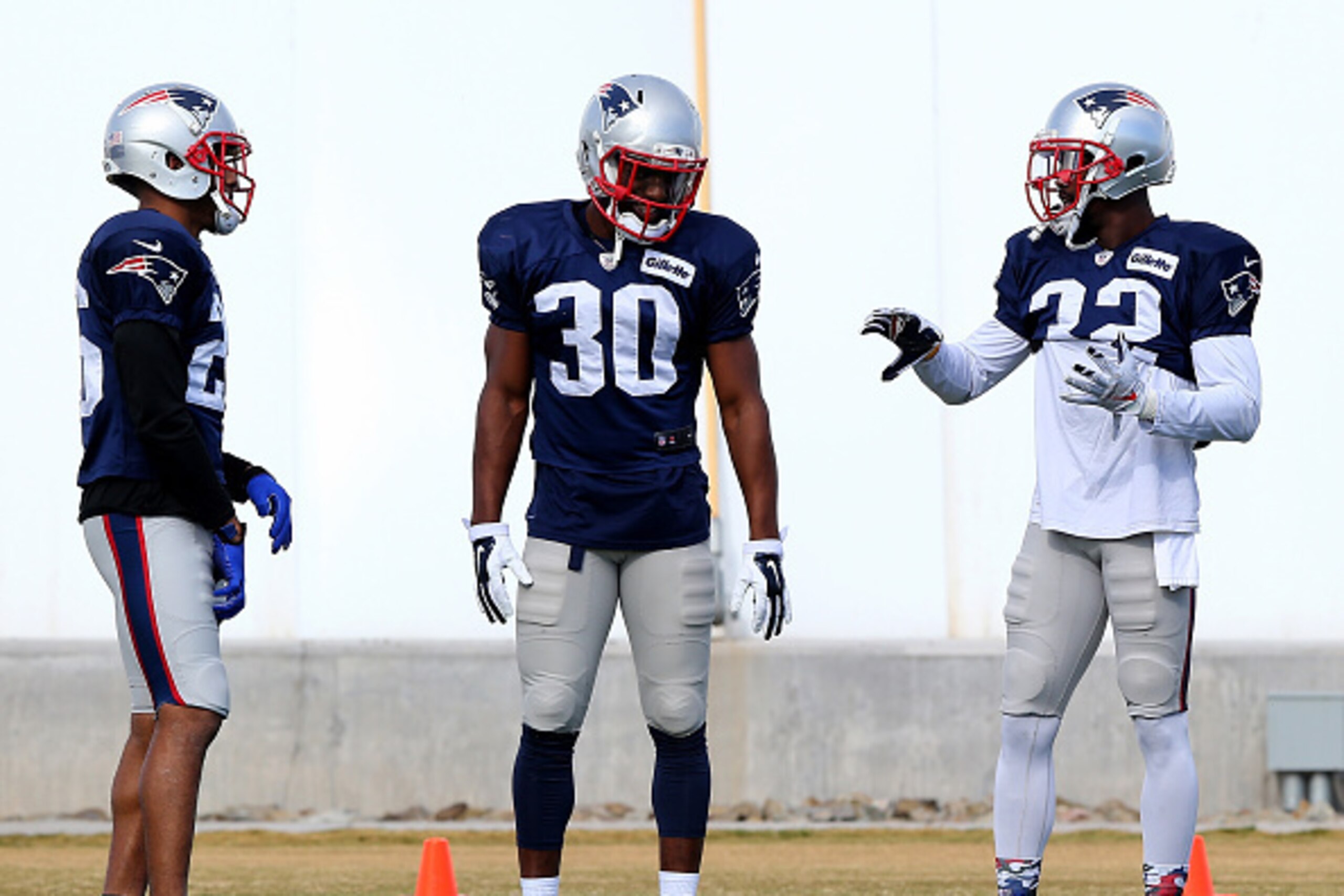 TEMPE, AZ - JANUARY 28:   Logan Ryan #26, Duron Harmon #30 and  Devin McCourty #32 of the New England Patriots talk during warmups before the New England Patriots Super Bowl XLIX Practice on January 28, 2015 at the Arizona Cardinals Practice Facility in T