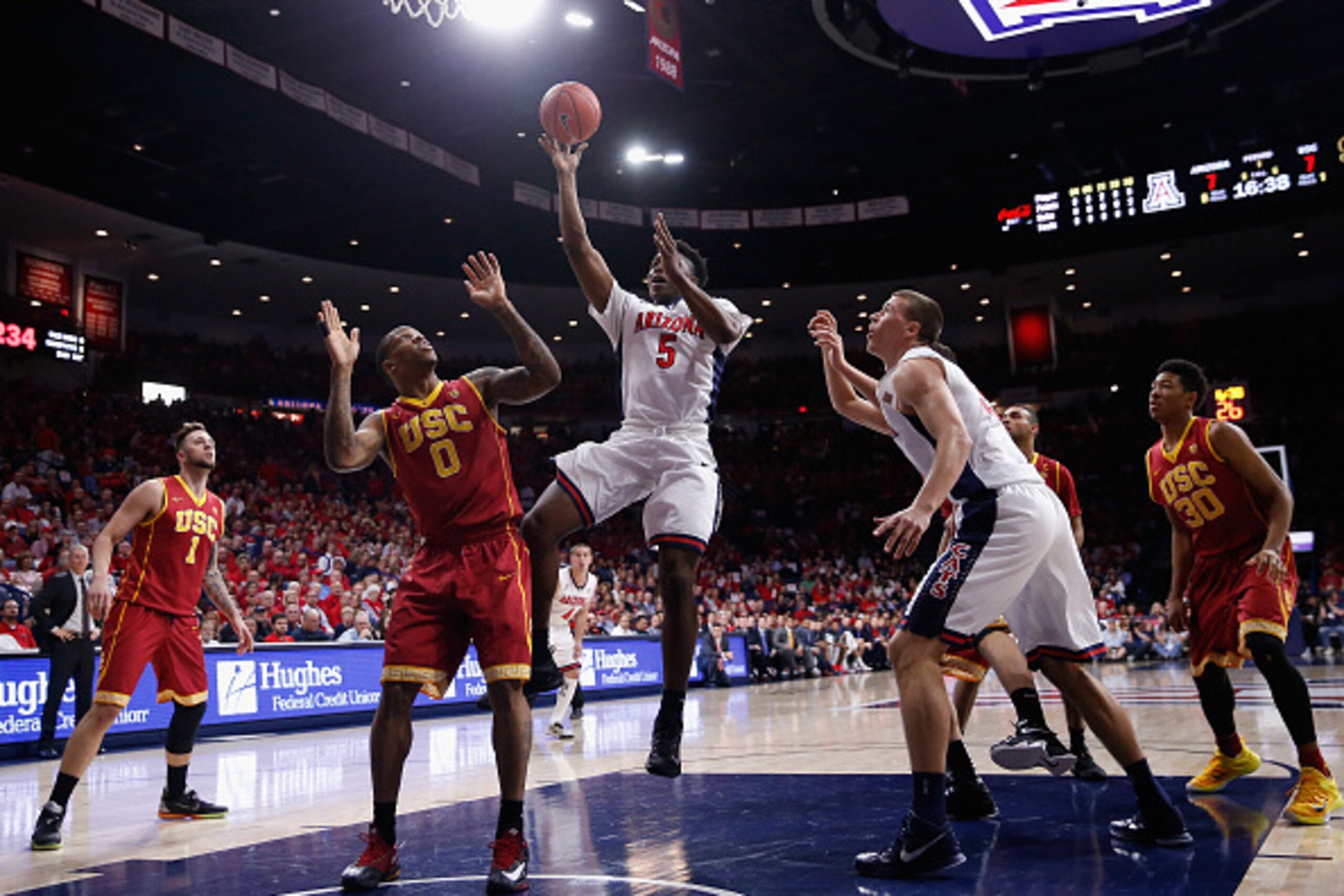 TUCSON, AZ - FEBRUARY 19:  Stanley Johnson #5 of the Arizona Wildcats puts up a shot over Darion Clark #0 of the USC Trojans during the first half of the college basketball game at McKale Center on February 19, 2015 in Tucson, Arizona.  (Photo by Christia