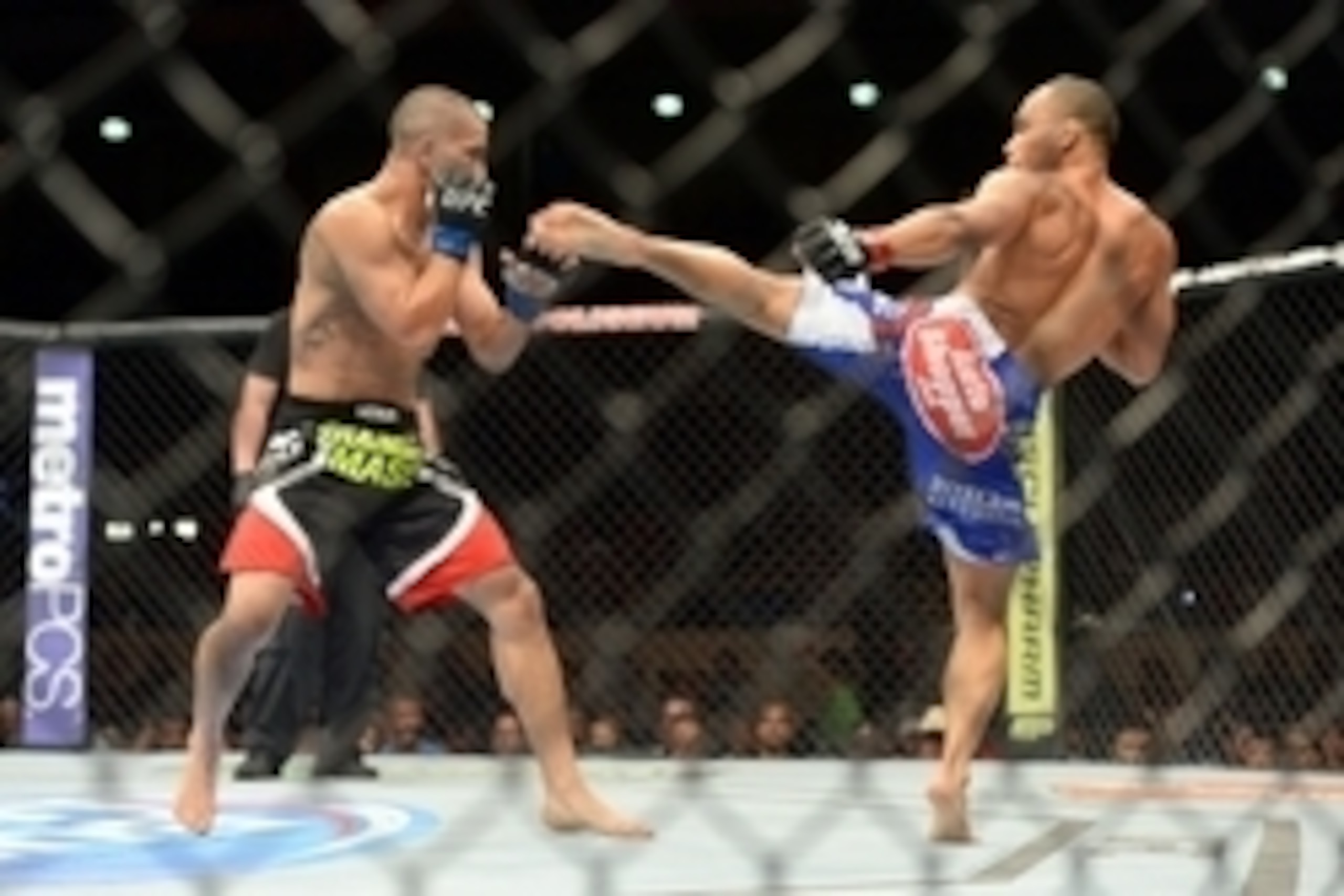 Jun 7, 2014; Albuquerque, NM, USA; John Dodson (red) and John Moraga (blue) fight during their flyweight bout during UFC Fight Night 42 at Tingley Coliseum. Dodson won after a doctor's stoppage at the end of round two. Mandatory Credit: Joe Camporeale-USA