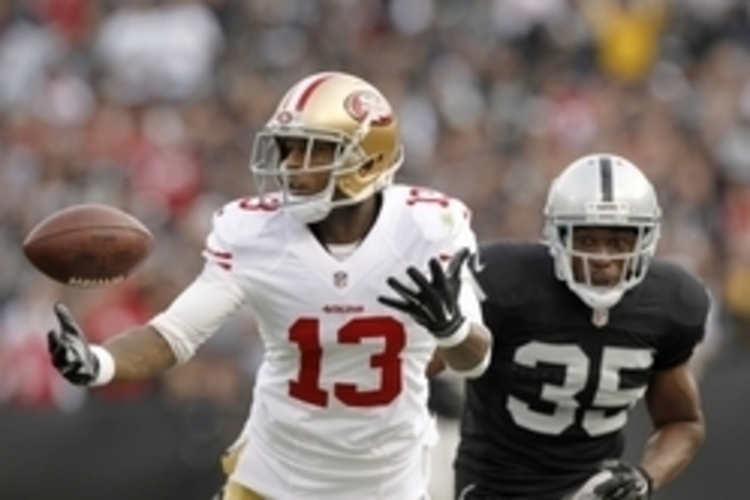 Dec 7, 2014; Oakland, CA, USA; San Francisco 49ers wide receiver Stevie Johnson (13) is unable to make a catch in front of Oakland Raiders defensive back Chimdi Chekwa (35) in the second quarter at O.co Coliseum. Mandatory Credit: Cary Edmondson-USA TODAY