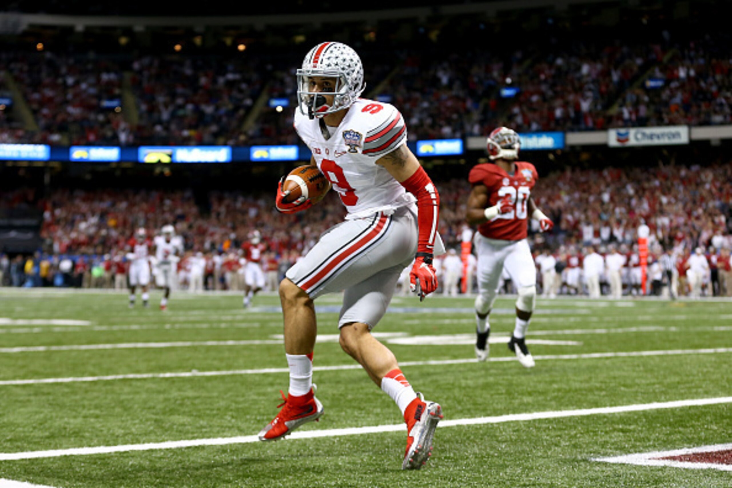 NEW ORLEANS, LA - JANUARY 01: Devin Smith #9 of the Ohio State Buckeyes catches a 47 yard touchdown pass in the third quarter against the Alabama Crimson Tide during the All State Sugar Bowl at the Mercedes-Benz Superdome on January 1, 2015 in New Orlean NEW ORLEANS, LA - JANUARY 01: Devin Smith #9 of the Ohio State Buckeyes catches a 47 yard touchdown pass in the third quarter against the Alabama Crimson Tide during the All State Sugar Bowl at the Mercedes-Benz Superdome on January 1, 2015 in New Orlean