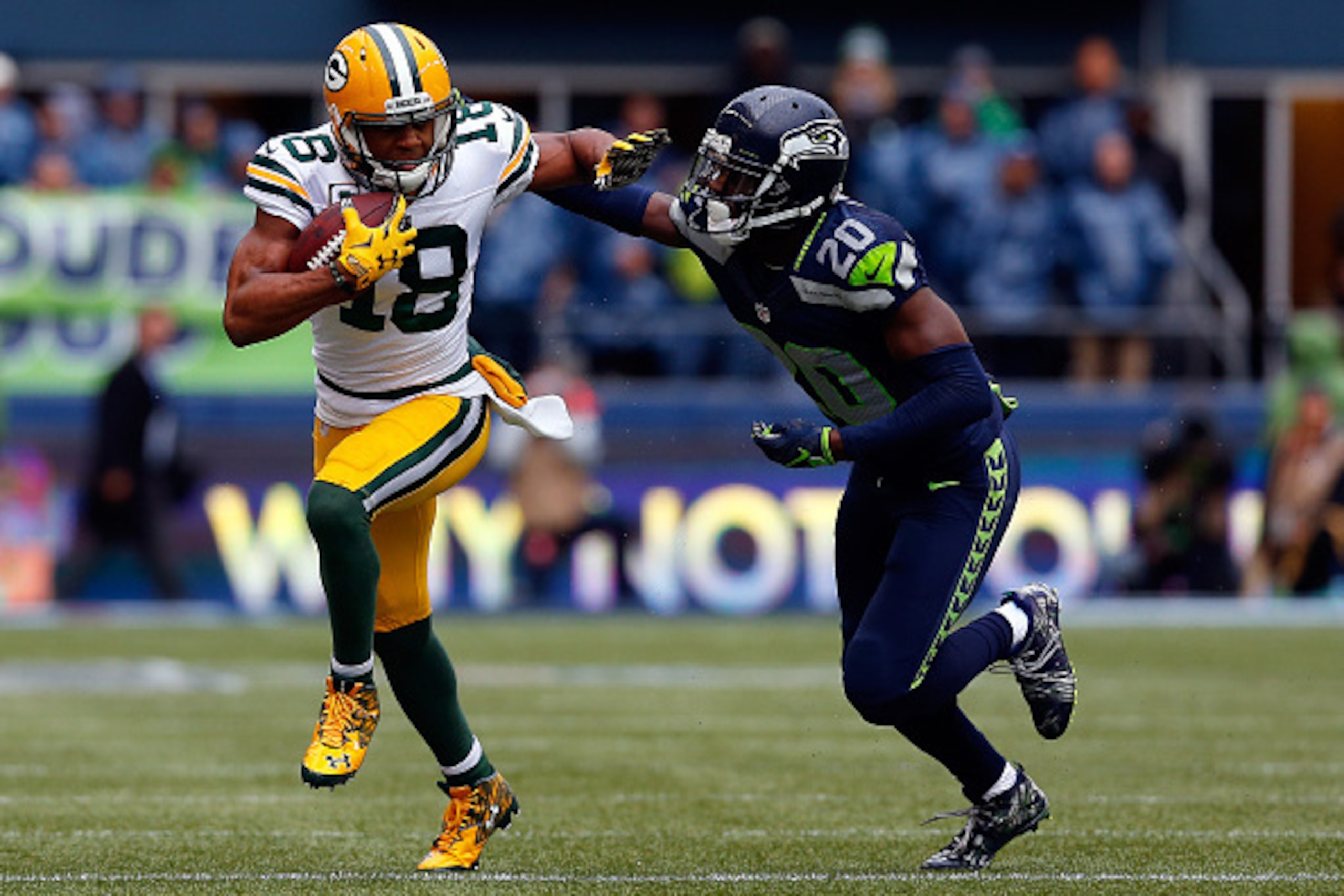 SEATTLE, WA - JANUARY 18: Randall Cobb #18 of the Green Bay Packers gives Jeremy Lane #20 of the Seattle Seahawks a stiff arm during the first quarter of the 2015 NFC Championship game at CenturyLink Field on January 18, 2015 in Seattle, Washington.  (Pho