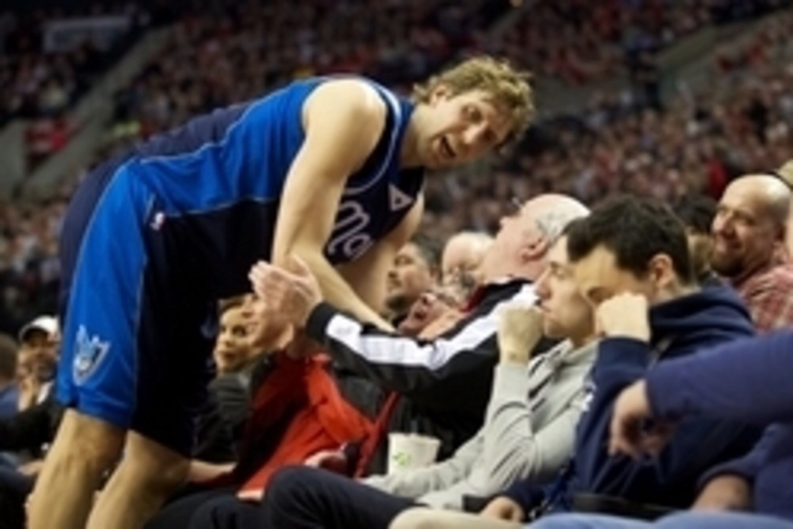 Mar 5, 2015; Portland, OR, USA; Dallas Mavericks forward Dirk Nowitzki (41) visits with fans after going for a loose ball against the Portland Trail Blazers at Moda Center at the Rose Quarter. Mandatory Credit: Jaime Valdez-USA TODAY Sports Mar 5, 2015; Portland, OR, USA; Dallas Mavericks forward Dirk Nowitzki (41) visits with fans after going for a loose ball against the Portland Trail Blazers at Moda Center at the Rose Quarter. Mandatory Credit: Jaime Valdez-USA TODAY Sports