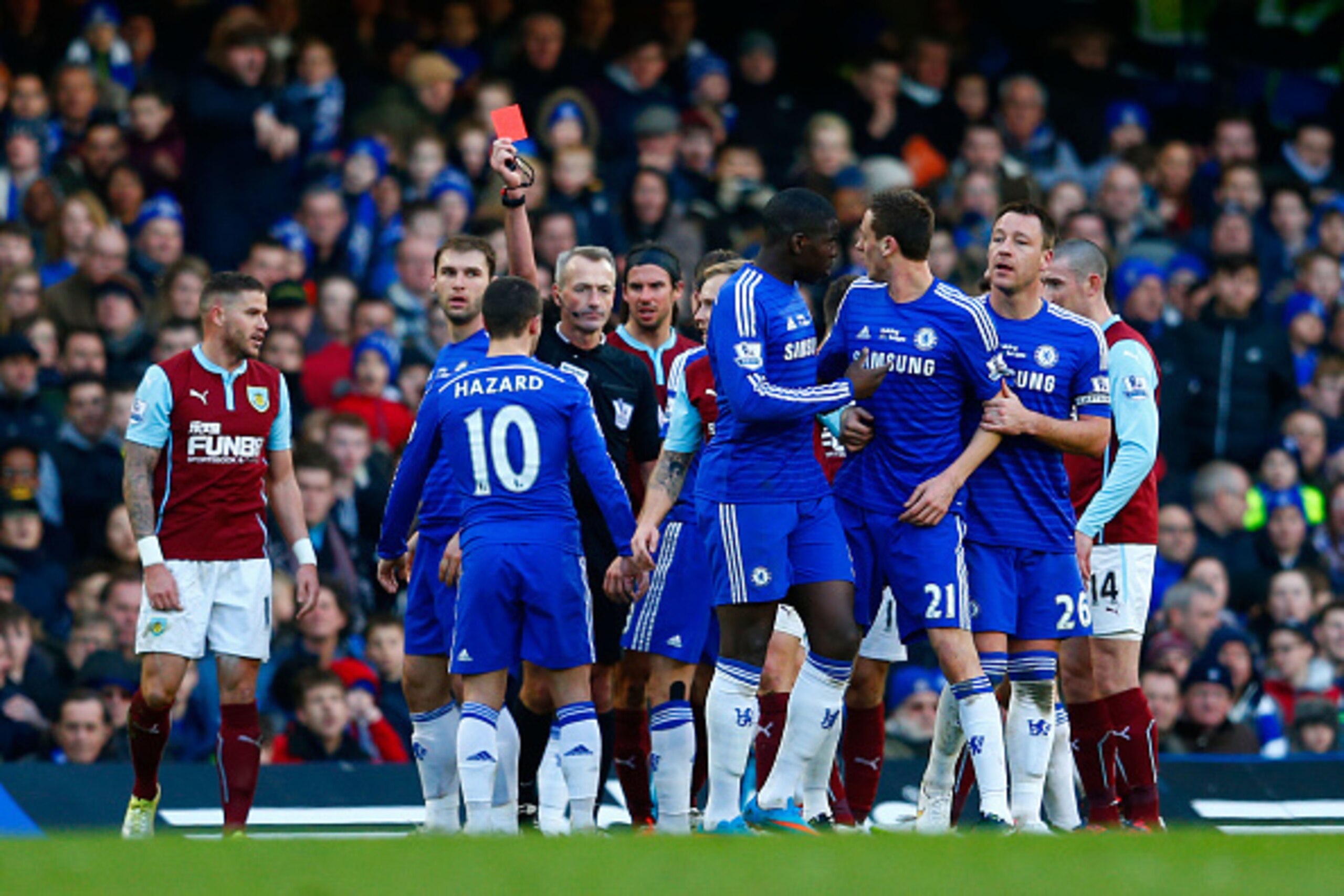 LONDON, ENGLAND - FEBRUARY 21:  Referee Martin Atkinson shows the red card to Nemanja Matic of Chelsea for his reaction to the tackle by Ashley Barnes of Burnley during the Barclays Premier League match between Chelsea and Burnley at Stamford Bridge on Fe