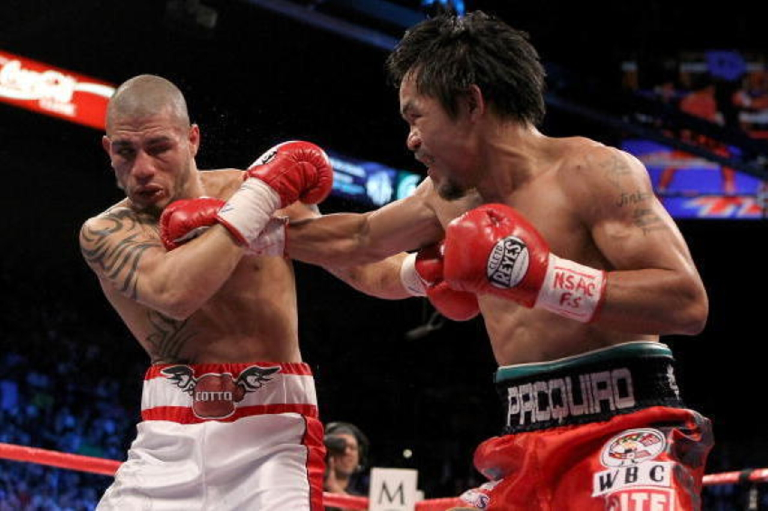 LAS VEGAS - NOVEMBER 14: (R-L) Manny Pacquiao throws a right to the head of Miguel Cotto during their WBO welterweight title fight at the MGM Grand Garden Arena on November 14, 2009 in Las Vegas, Nevada. (Photo by Al Bello/Getty Images) LAS VEGAS - NOVEMBER 14: (R-L) Manny Pacquiao throws a right to the head of Miguel Cotto during their WBO welterweight title fight at the MGM Grand Garden Arena on November 14, 2009 in Las Vegas, Nevada. (Photo by Al Bello/Getty Images)