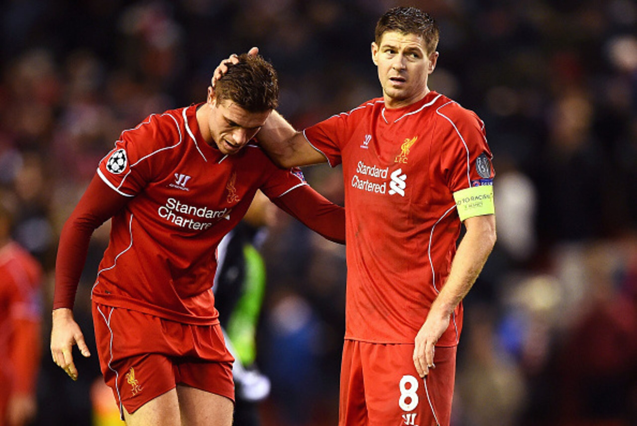 LIVERPOOL, ENGLAND - DECEMBER 09:  (L-R) Dejected Liverpool players Jordan Henderson and Steven Gerrard react following their team's 1-1 draw and exit from the competition during the UEFA Champions League group B match between Liverpool and FC Basel 1893 