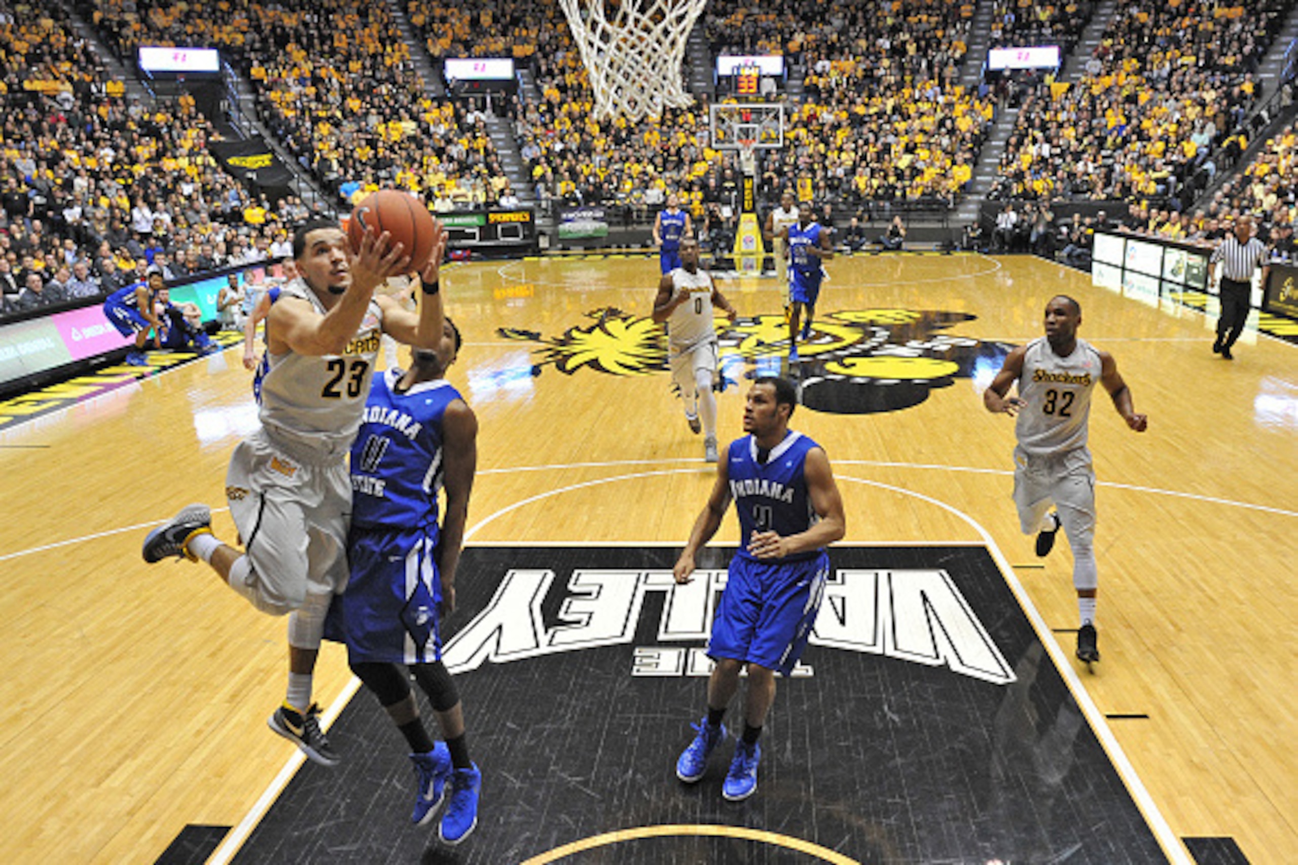 WICHITA, KS - FEBRUARY 11: Guard Fred Van Vleet #23 of the Wichita State Shockers scores past guard Devonte Brown #11 of the Indiana State Sycamores during the first half on February 11, 2015 at Charles Koch Arena in Wichita, Kansas. Wichita State defeate