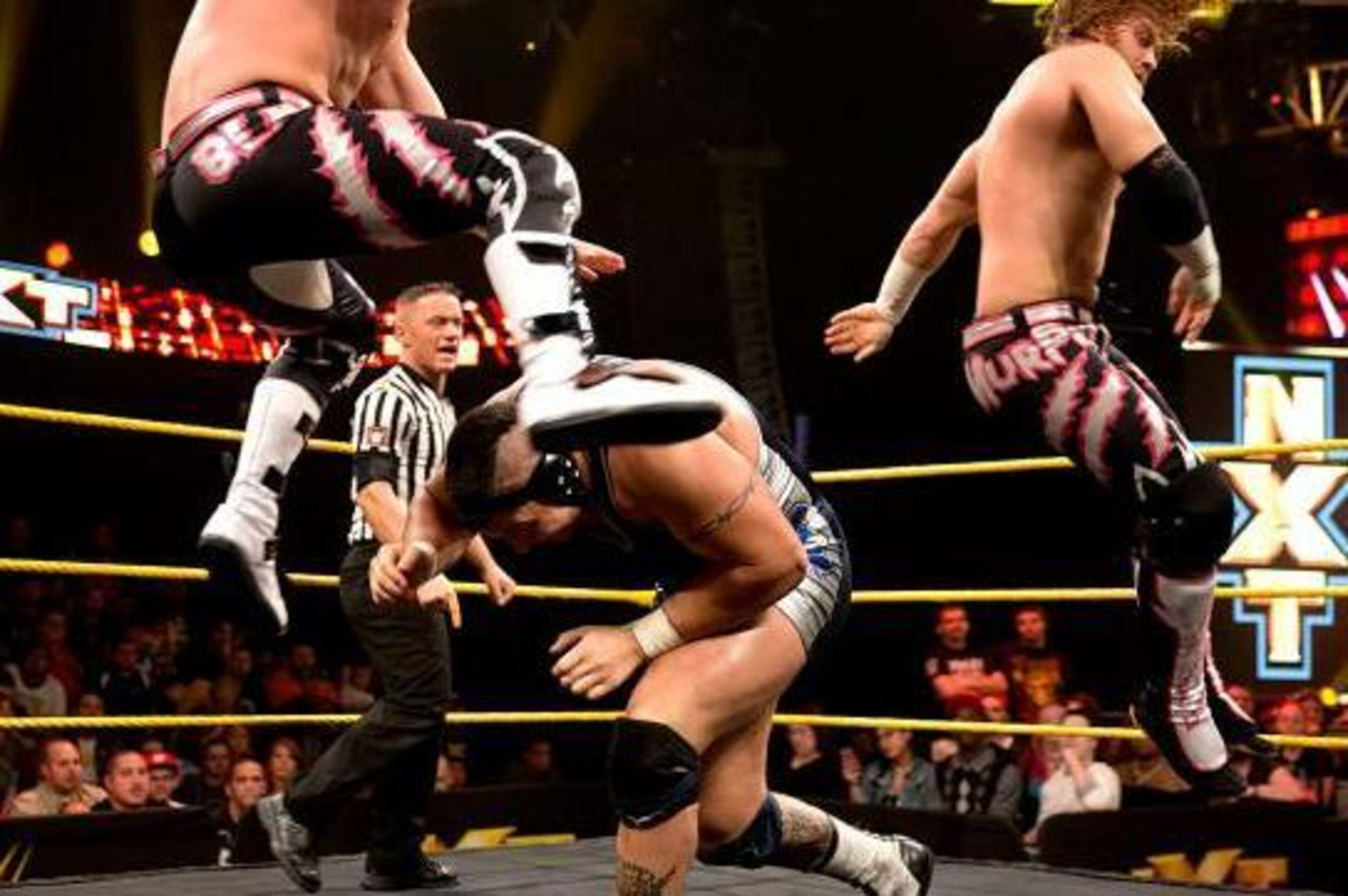 Sawyer Fulton ducks under the tag team champs. Sawyer Fulton ducks under the tag team champs.