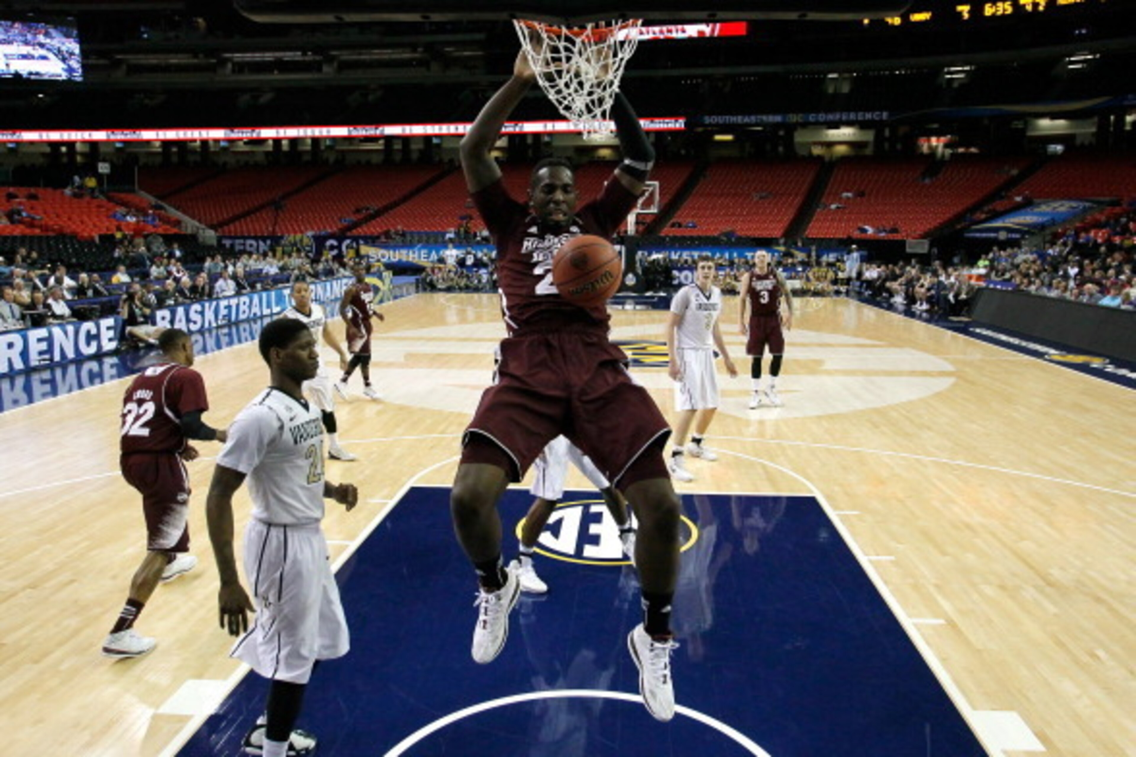 ATLANTA, GA - MARCH 12:  Gavin Ware #20 of the Mississippi State Bulldogs dunks against Dai-Jon Parker #24 of the Vanderbilt Commodores during the first round of the SEC Men's Basketball Tournament at Georgia Dome on March 12, 2014 in Atlanta, Georgia.  (