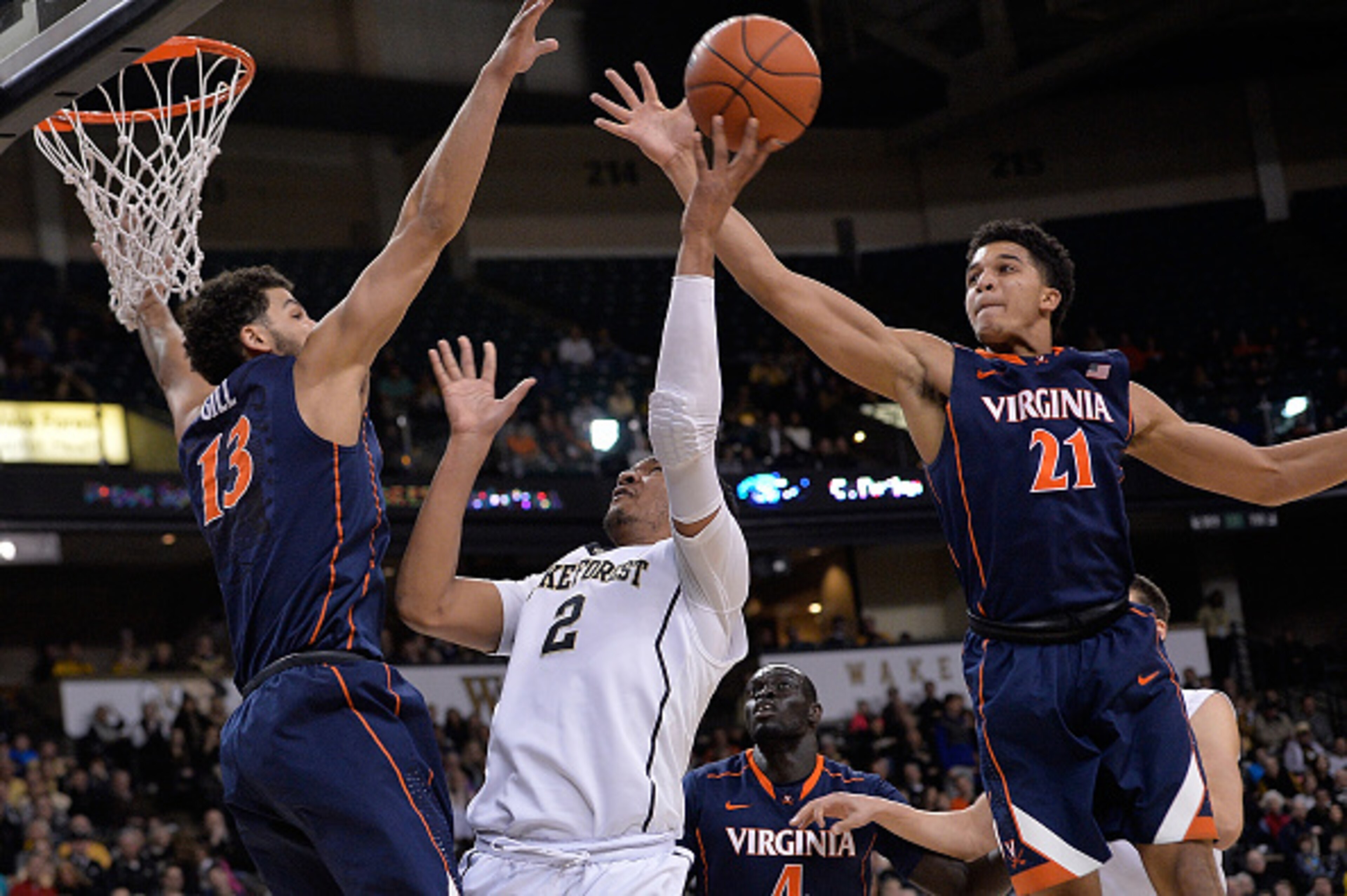 WINSTON-SALEM, NC - FEBRUARY 25: Devin Thomas #2 of the Wake Forest Demon Deacons drives between Anthony Gill #13 and Isaiah Wilkins #21 of the Virginia Cavaliers during their game at the LJVM Coliseum Complex on February 25, 2015 in Winston-Salem, North WINSTON-SALEM, NC - FEBRUARY 25: Devin Thomas #2 of the Wake Forest Demon Deacons drives between Anthony Gill #13 and Isaiah Wilkins #21 of the Virginia Cavaliers during their game at the LJVM Coliseum Complex on February 25, 2015 in Winston-Salem, North