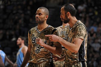 SAN ANTONIO, TX - MARCH 6:  Tony Parker #9 and Manu Ginobili #20 of the San Antonio Spurs talk during the game against the Denver Nuggets on March 6, 2015 at the AT&T Center in San Antonio, Texas. NOTE TO USER: User expressly acknowledges and agrees that,