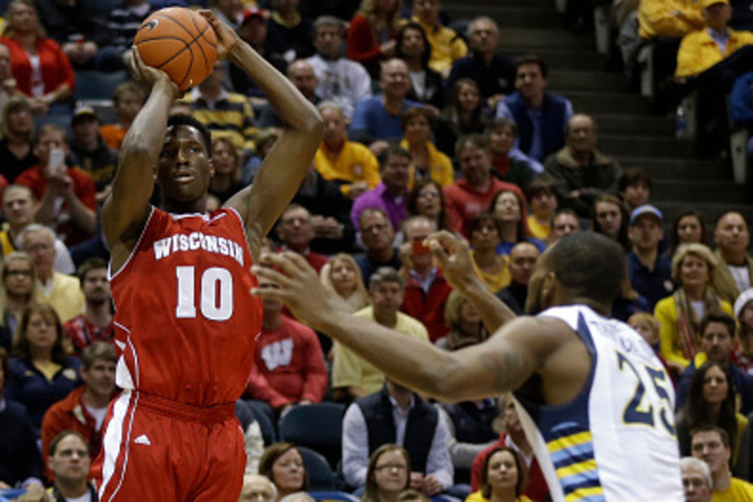 MILWAUKEE, WI - DECEMBER 06: Nigel Hayes #10 of the Wisconsin Badgers shoots a three pointer during the first half against  the Marquette Golden Eagles of the Wisconsin Badgers at BMO Harris Bradley Center on December 06, 2014 in Milwaukee, Wisconsin. (Ph