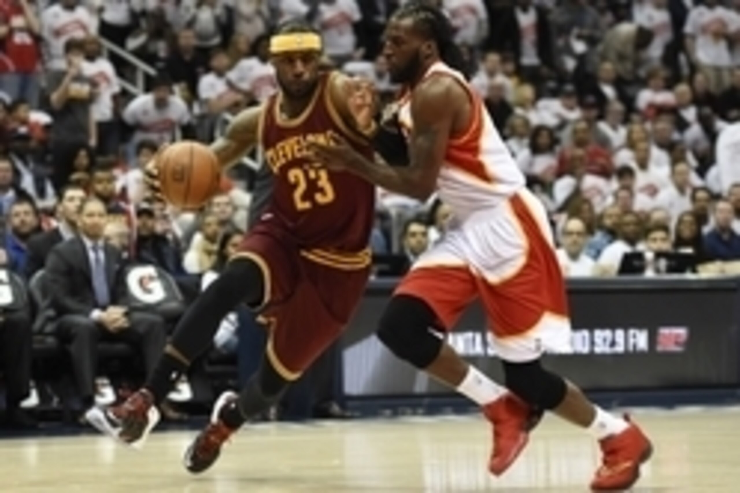Mar 6, 2015; Atlanta, GA, USA; Cleveland Cavaliers forward LeBron James (23) dribbles the ball as Atlanta Hawks forward DeMarre Carroll (5) defends during the first half at Philips Arena. Mandatory Credit: Dale Zanine-USA TODAY Sports