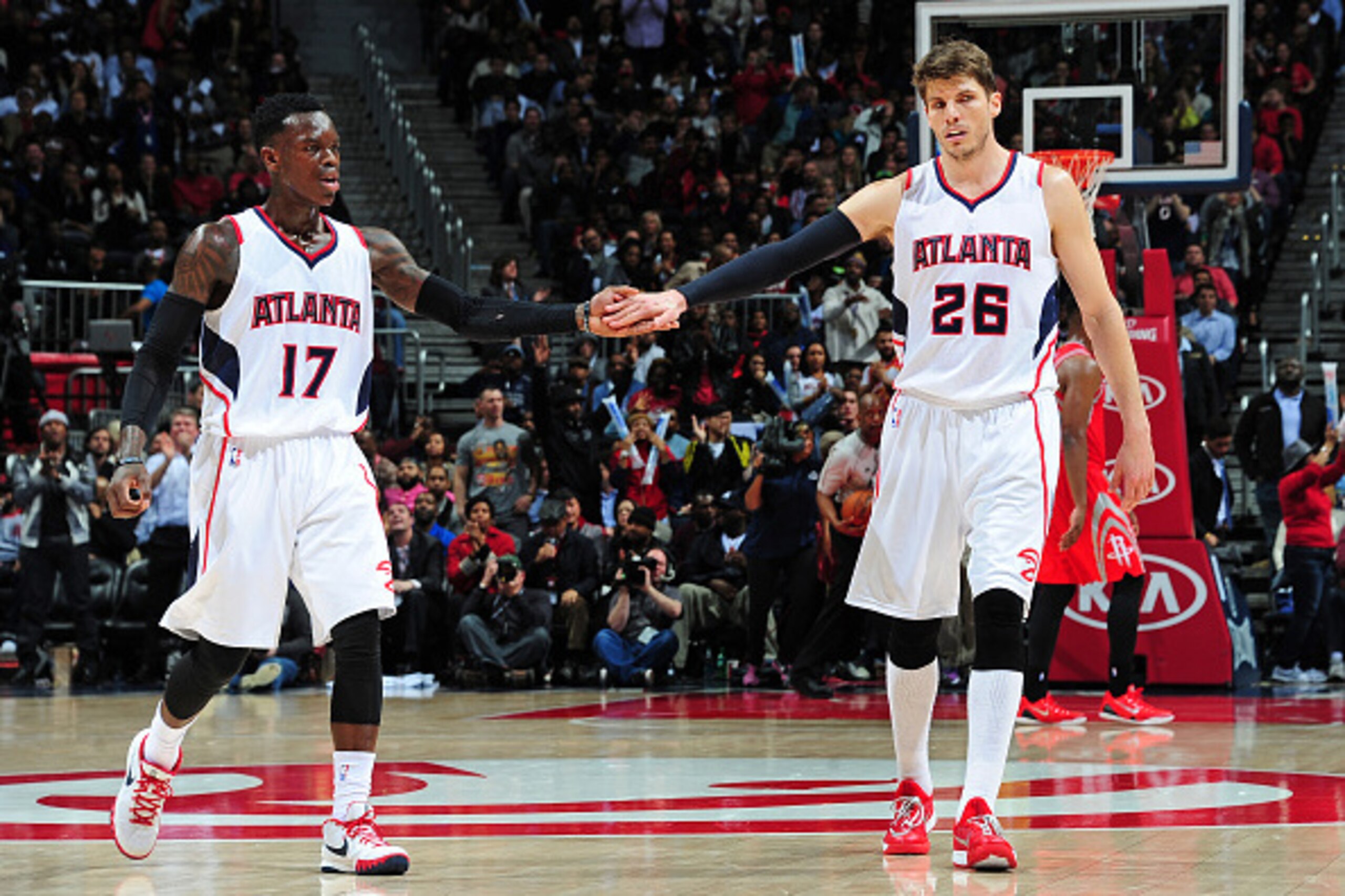 ATLANTA, GA - MARCH 3: Dennis Schroder #17 and Kyle Korver #26 of the Atlanta Hawks celebrate after sore against the Houston Rockets on March 3, 2015 at Philips Arena in Atlanta, Georgia.  NOTE TO USER: User expressly acknowledges and agrees that, by down