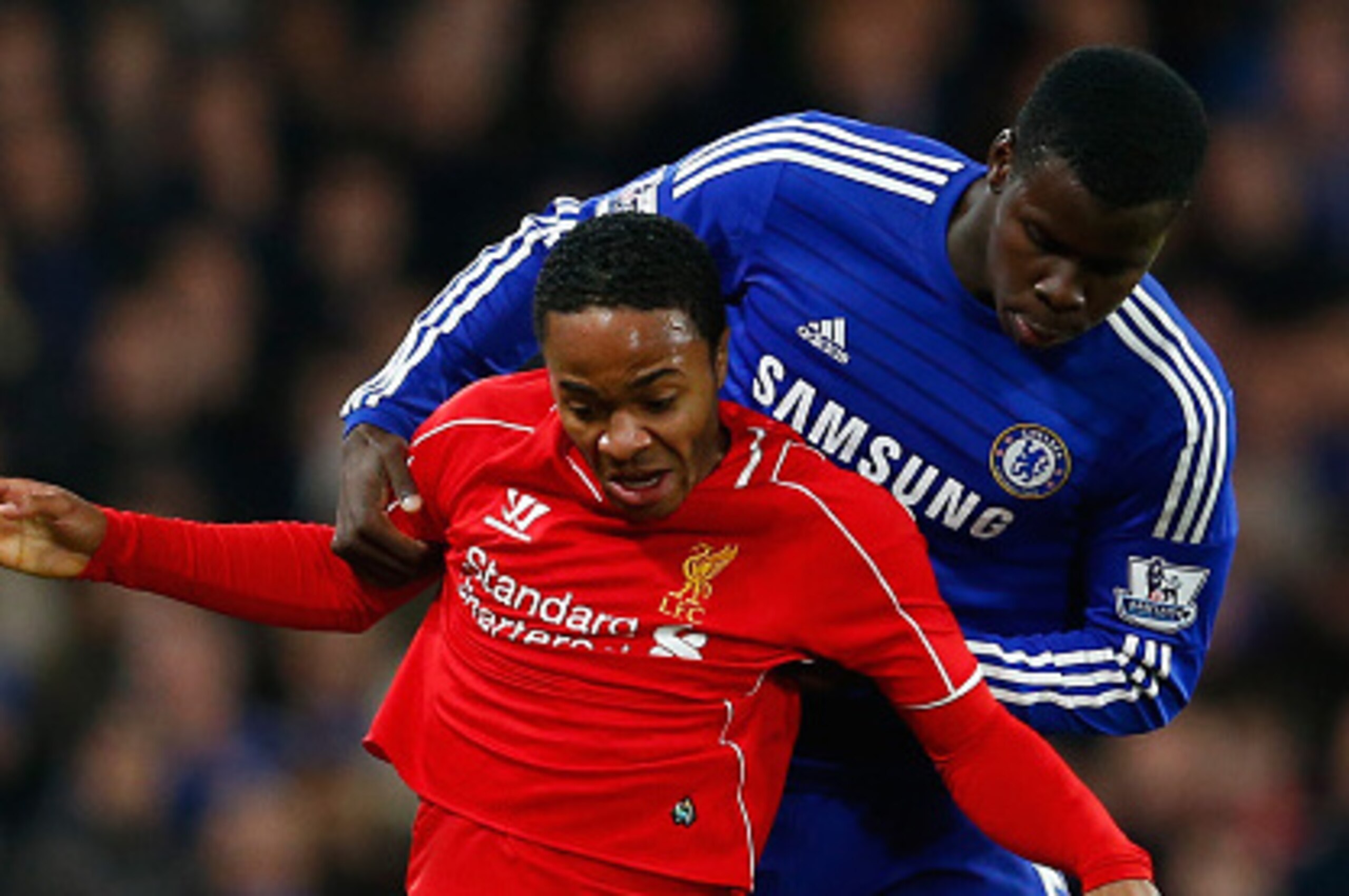 LONDON, ENGLAND - JANUARY 27: Raheem Sterling of Liverpool holds off Kurt Zouma of Chelsea during the Capital One Cup Semi-Final second leg between Chelsea and Liverpool at Stamford Bridge on January 27, 2015 in London, England.  (Photo by Julian Finney/G