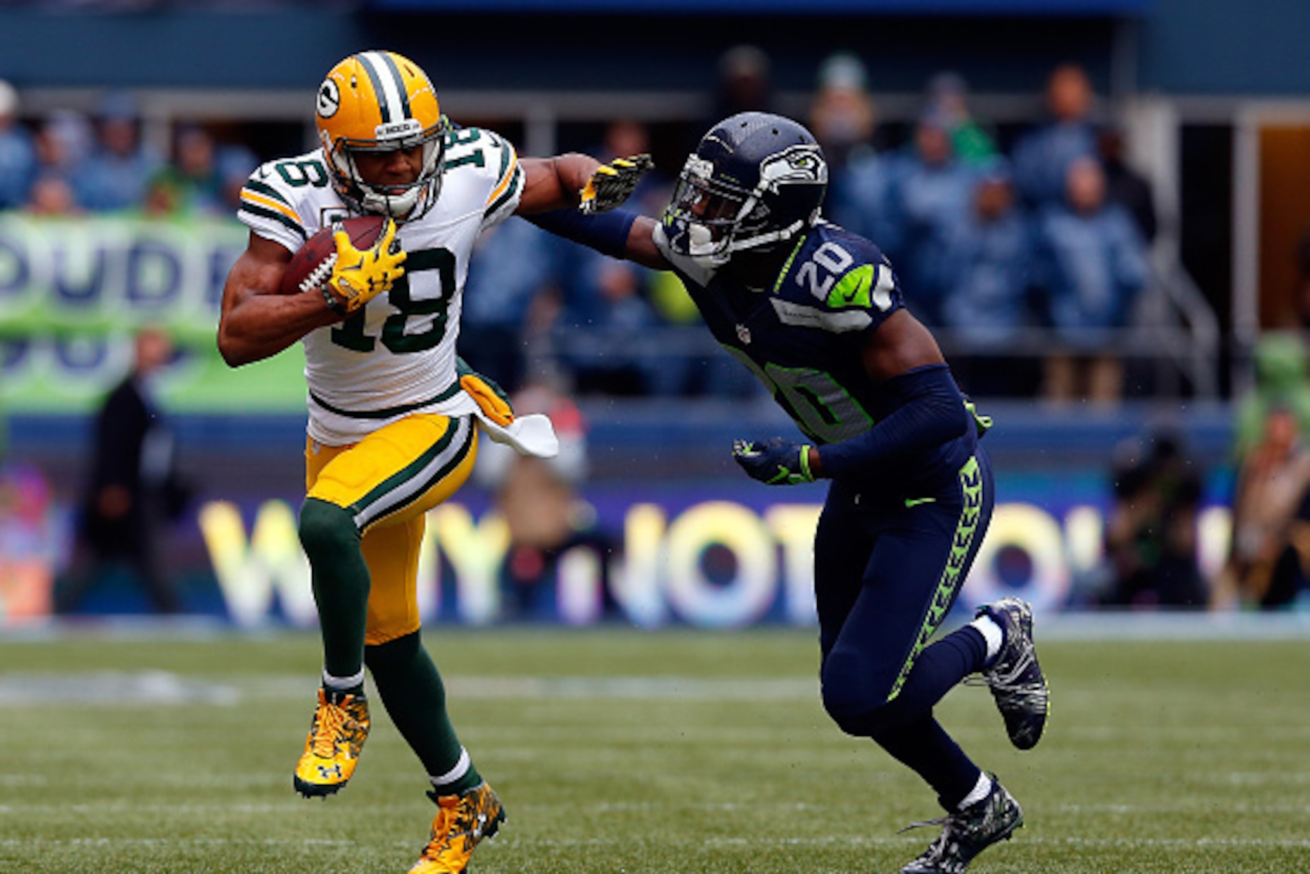 SEATTLE, WA - JANUARY 18: Randall Cobb #18 of the Green Bay Packers gives Jeremy Lane #20 of the Seattle Seahawks a stiff arm during the first quarter of the 2015 NFC Championship game at CenturyLink Field on January 18, 2015 in Seattle, Washington.  (Pho