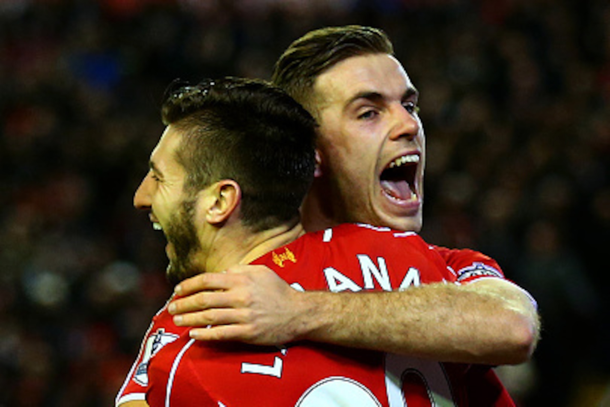 LIVERPOOL, ENGLAND - DECEMBER 29:  Adam Lallana of Liverpool celebrates with team-mate Jordan Henderson of Liverpool after scoring his team's second goal during the Barclays Premier League match between Liverpool and Swansea City at Anfield on December 29
