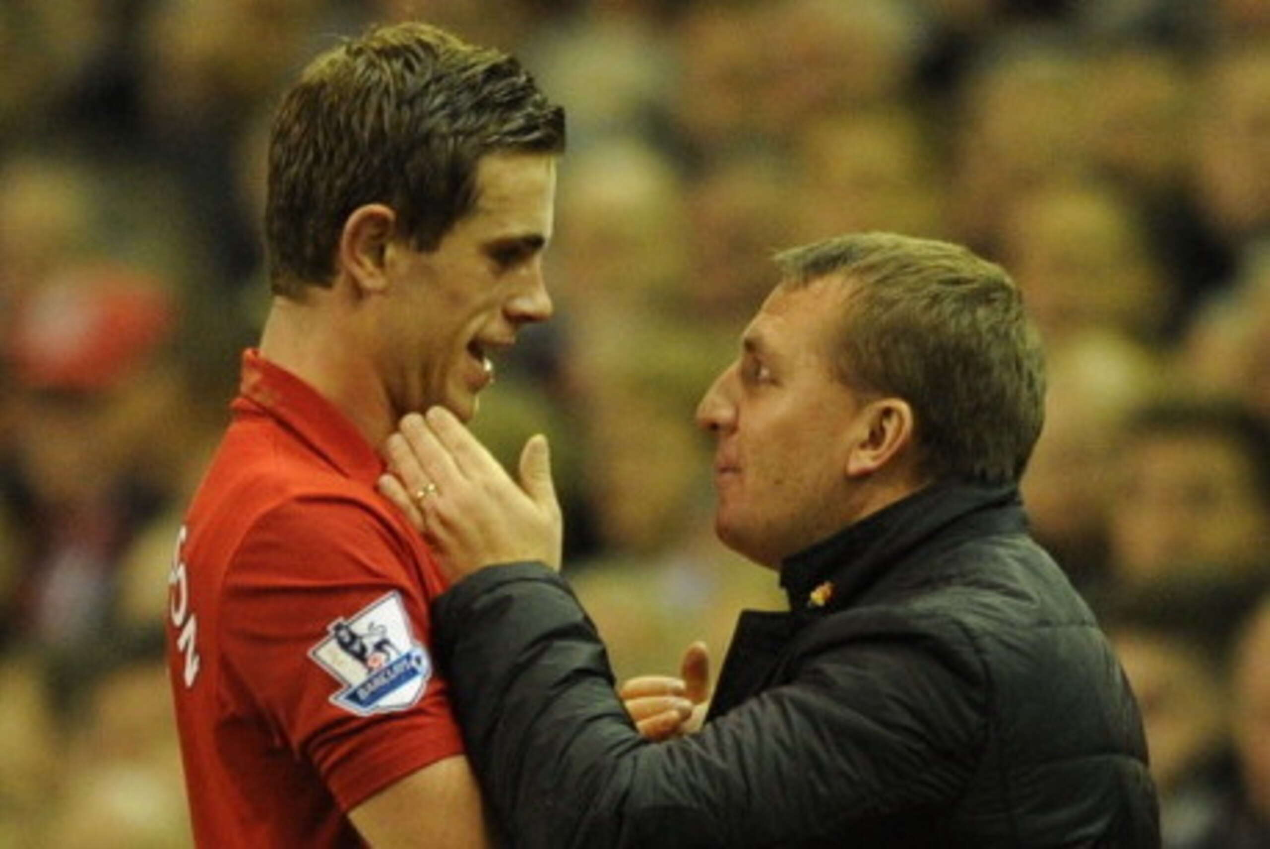 LIVERPOOL, ENGLAND - JANUARY 02:  Jordan Henderson of Liverpool is embraced by Manager Brendan Rodgers during the Barclays Premier League match between Liverpool and Sunderland at Anfield on January 2, 2013 in Liverpool, England.  (Photo by Chris Brunskil