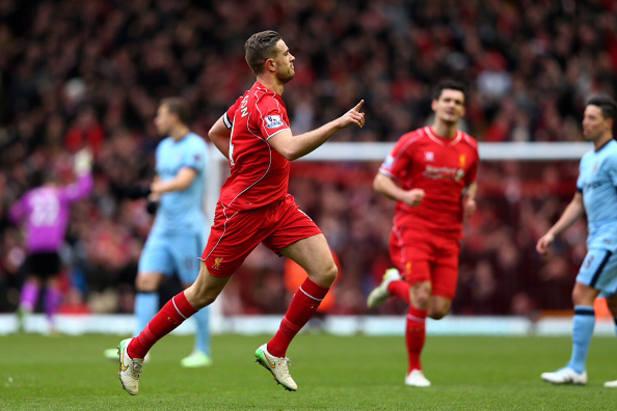 LIVERPOOL, ENGLAND - MARCH 01:  Jordan Henderson (L) of Liverpool celebrates after scoring the opening goal during the Barclays Premier League match between Liverpool and Manchester City at Anfield on March 1, 2015 in Liverpool, England.  (Photo by Clive 