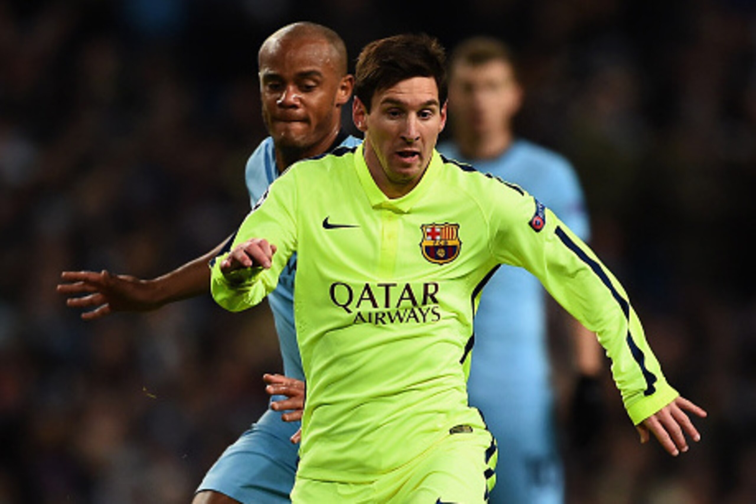 MANCHESTER, ENGLAND - FEBRUARY 24: Lionel Messi of Barcelona skips past Vincent Kompany of Manchester City during the UEFA Champions League Round of 16 match between Manchester City and Barcelona at Etihad Stadium on February 24, 2015 in Manchester, Unite