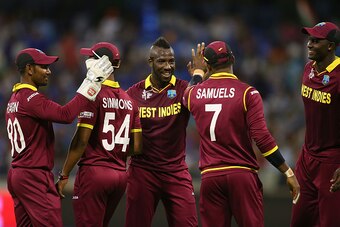 PERTH, AUSTRALIA - MARCH 06: Andre Russell of the West Indies celebrates the wicket of Ravindra Jadeja of India during the 2015 ICC Cricket World Cup match between India and the West Indies at WACA on March 6, 2015 in Perth, Australia.  (Photo by Paul Kan