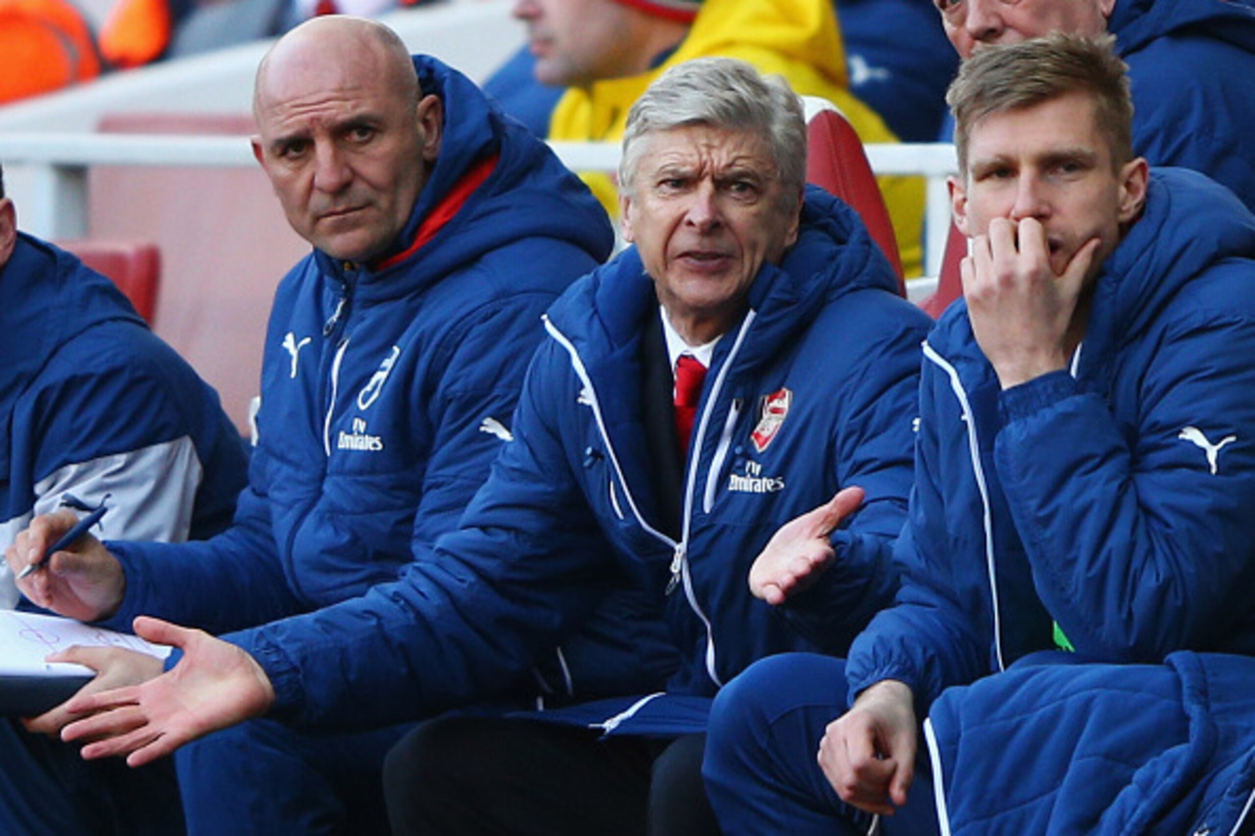 LONDON, ENGLAND - MARCH 01: Arsene Wenger manager of Arsenal (C) reacts alongside assistant Steve Bould (L) and Per Mertesacker (R) during the Barclays Premier League match between Arsenal and Everton at Emirates Stadium on March 1, 2015 in London, Engla LONDON, ENGLAND - MARCH 01: Arsene Wenger manager of Arsenal (C) reacts alongside assistant Steve Bould (L) and Per Mertesacker (R) during the Barclays Premier League match between Arsenal and Everton at Emirates Stadium on March 1, 2015 in London, Engla