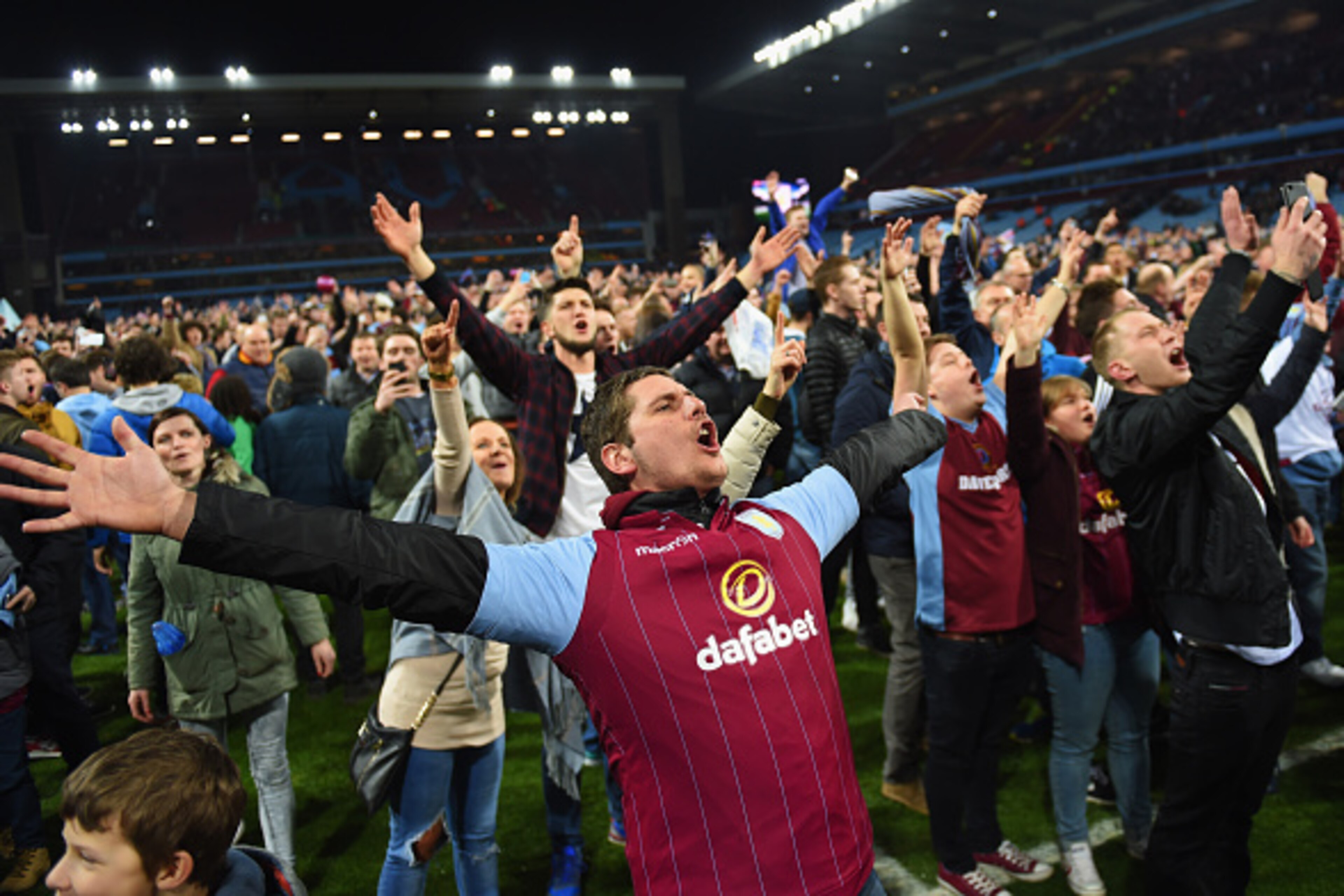 BIRMINGHAM, ENGLAND - MARCH 07:  Aston Villa fans celebrate victory on the pitch after the FA Cup Quarter Final match between Aston Villa and West Bromwich Albion at Villa Park on March 7, 2015 in Birmingham, England.  (Photo by Michael Regan/Getty Images