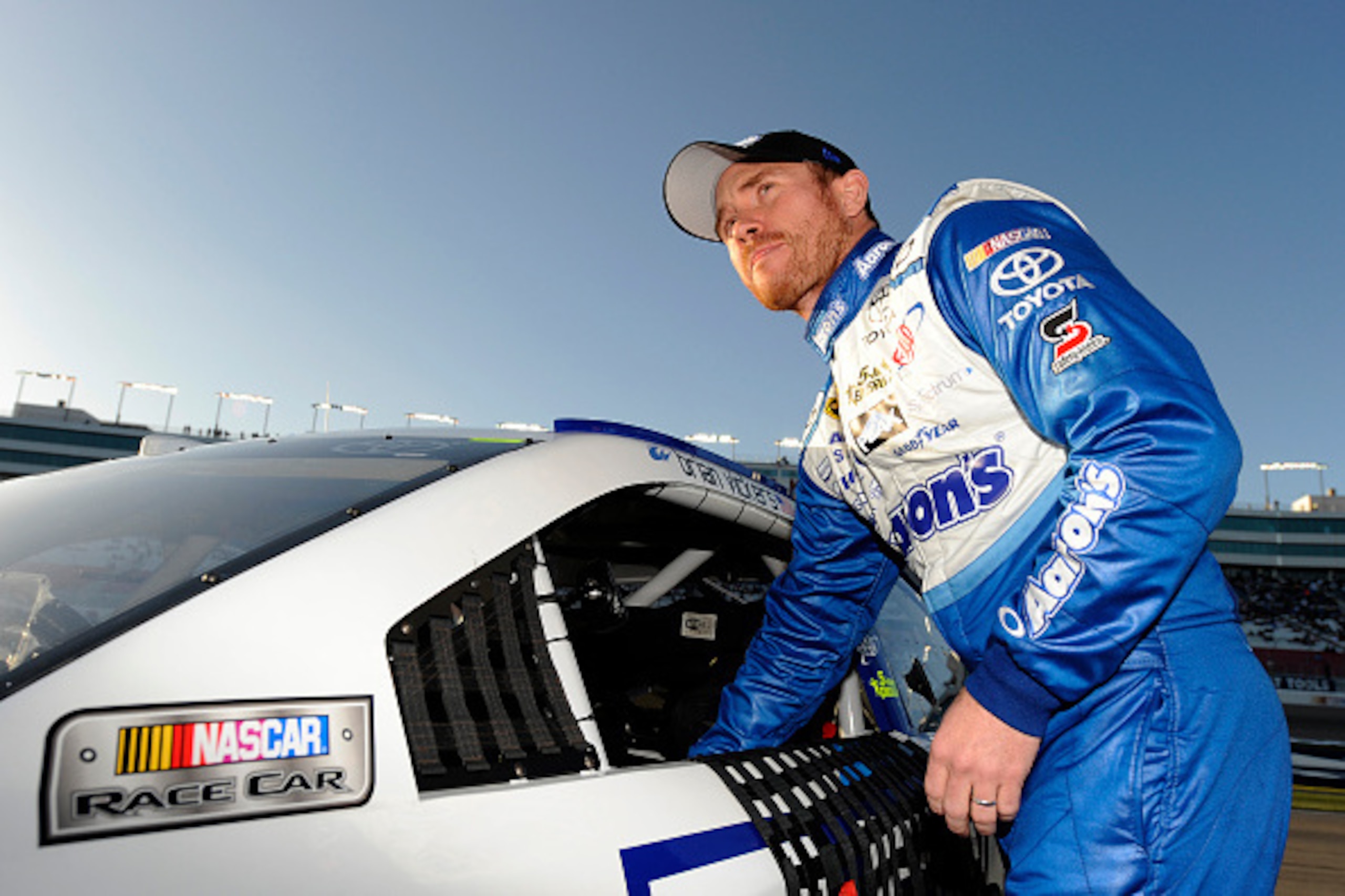LAS VEGAS, NV - MARCH 06:  Brian Vickers, driver of the #55 Aaron's 60th Anniversary Dream Machine Toyota, stands on the grid during qualifying for the NASCAR Sprint Cup Series Kobalt 400 at Las Vegas Motor Speedway on March 6, 2015 in Las Vegas, Nevada. 