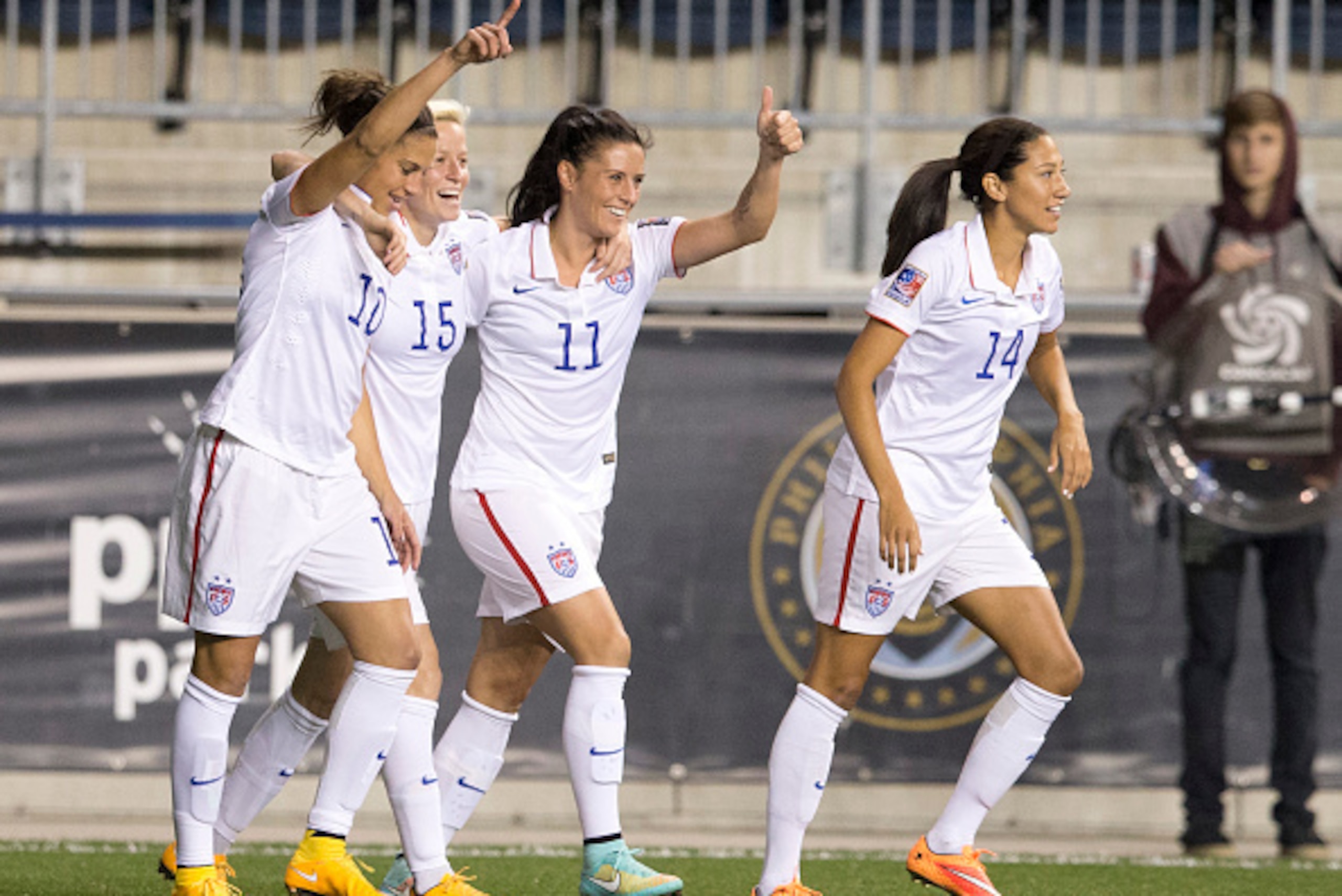 CHESTER, PA - OCTOBER 24: Carli Lloyd #10, Megan Rapinoe #15, Ali Krieger #11 and Christen Press #14 of the United States react after Lloyd scored a goal in the first half against Mexico in the 2014 CONCACAF Women's Championship semifinal game on October 