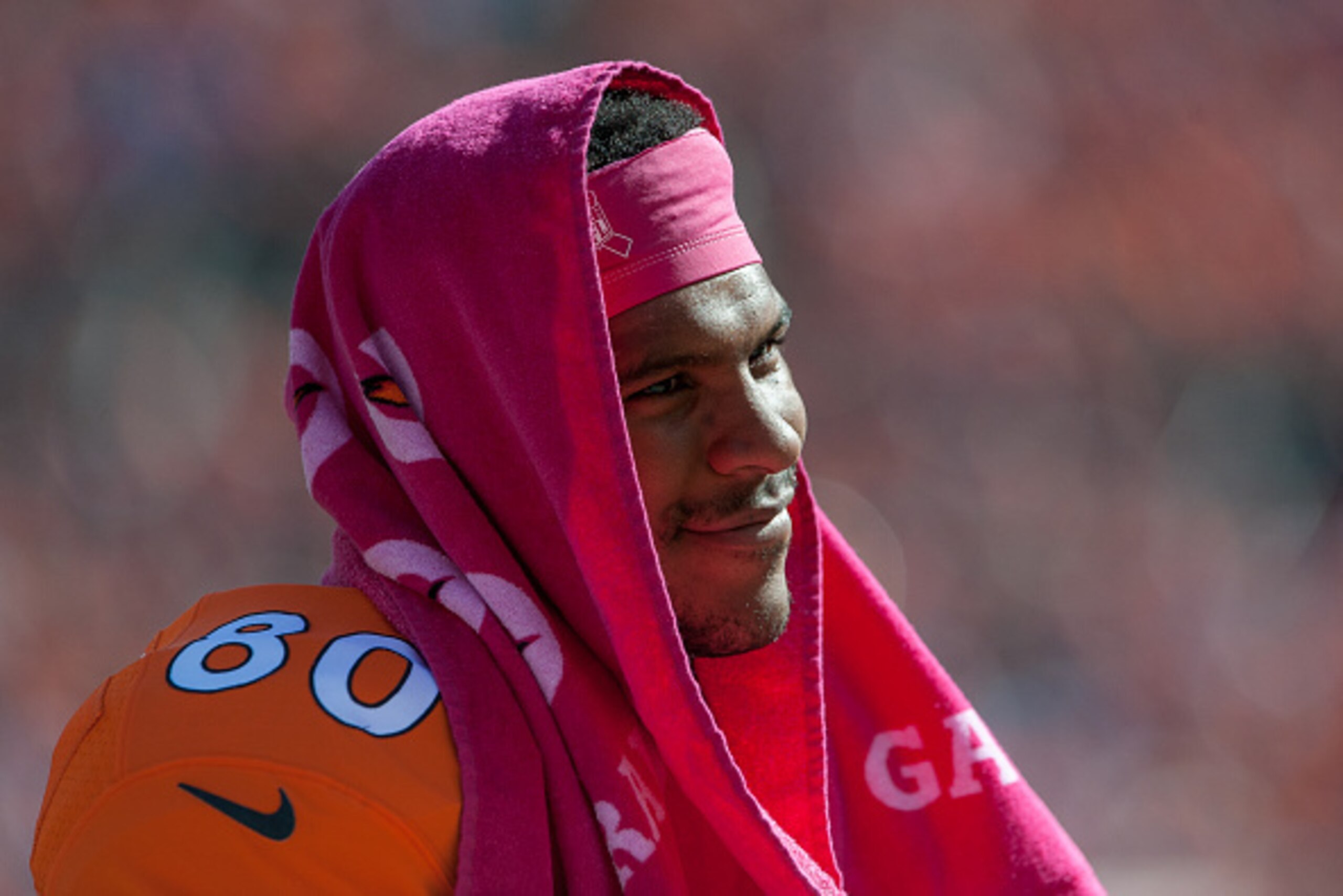 DENVER, CO - OCTOBER 5:  Tight end Julius Thomas #80 of the Denver Broncos smiles as he wears a pink towel for Breast Cancer Awareness month over his head for shade before the start of a game against the Arizona Cardinals at Sports Authority Field at Mile