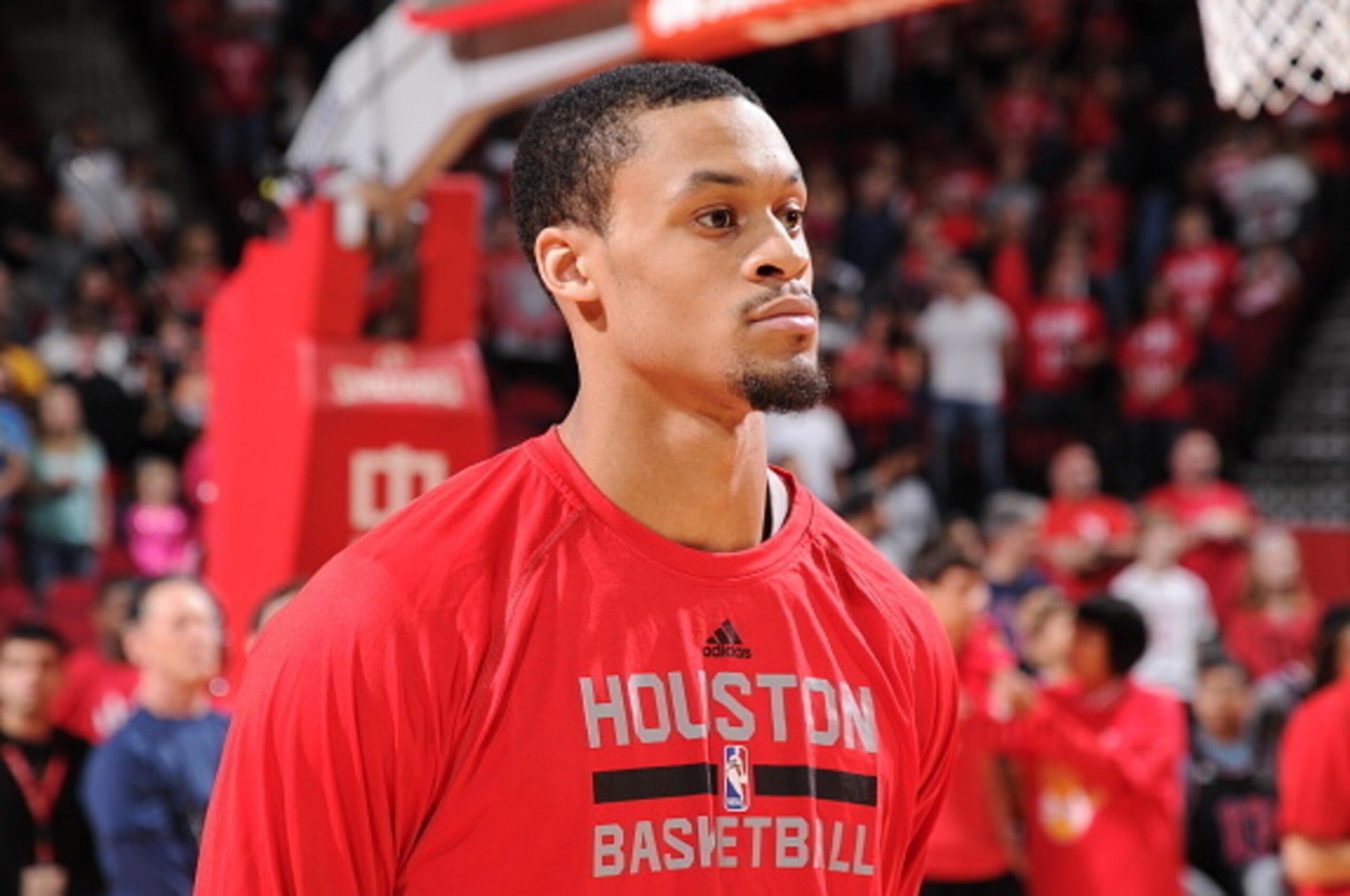 HOUSTON, TX - FEBRUARY 21: K.J. McDaniels #32 of the Houston Rockets stands for the national anthem before a game against the Toronto Raptors on February 21, 2015 at the Toyota Center in Houston, Texas. NOTE TO USER: User expressly acknowledges and agrees