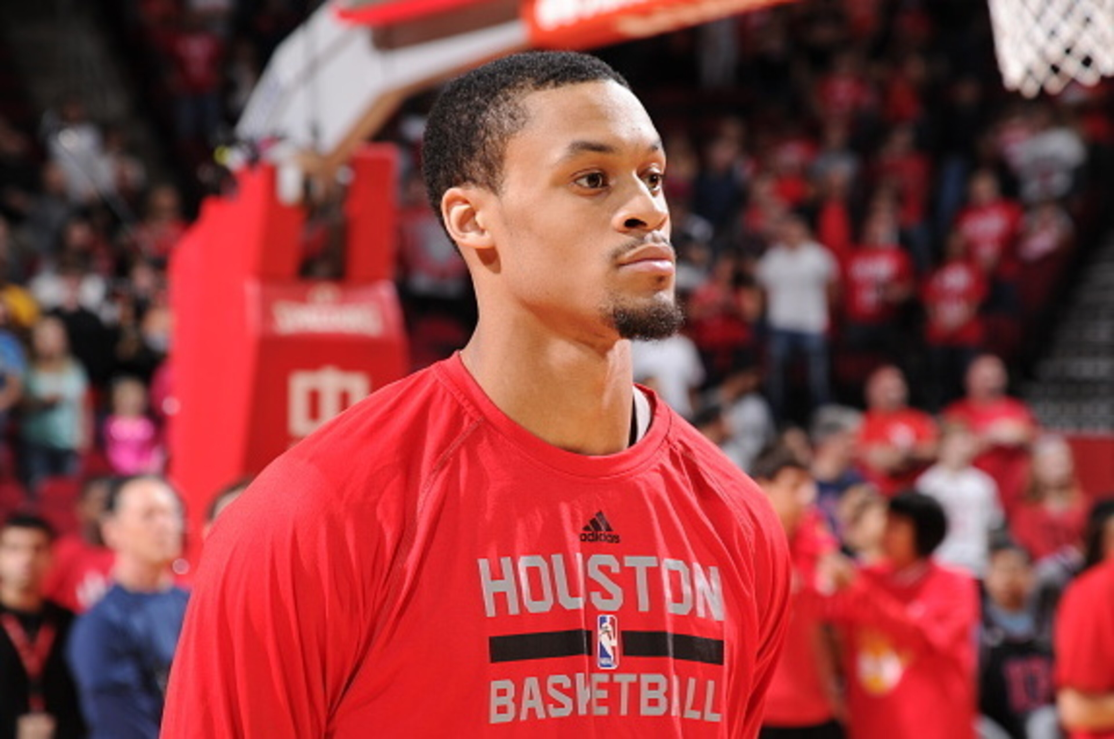 HOUSTON, TX - FEBRUARY 21: K.J. McDaniels #32 of the Houston Rockets stands for the national anthem before a game against the Toronto Raptors on February 21, 2015 at the Toyota Center in Houston, Texas. NOTE TO USER: User expressly acknowledges and agrees
