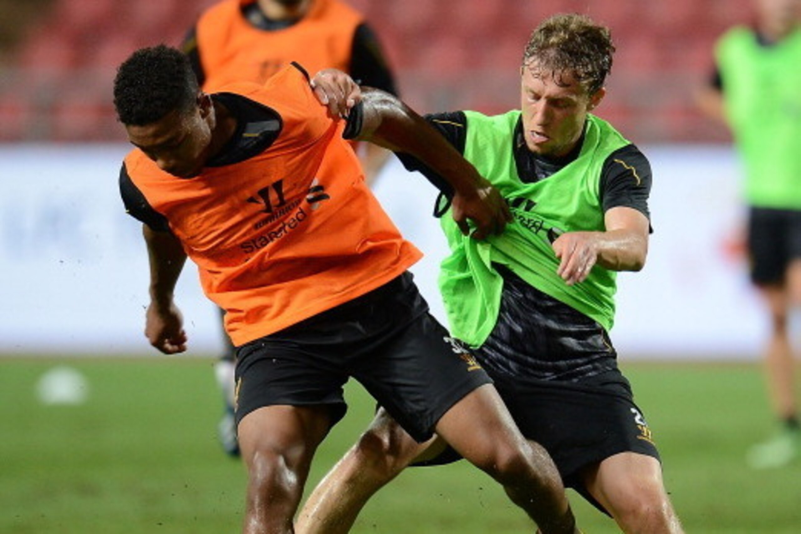 BANGKOK, THAILAND - JULY 27: Jerome Sinclair wins the ball from Lucas Leiva during a Liverpool FC training session at Rajamangala Stadium on July 27, 2013 in Bangkok, Thailand.  (Photo by Thananuwat Srirasant/Getty Images)