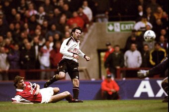 14 Apr 1999:  Ryan Giggs of Manchester United beats the despairing lunge of Tony Adams of Arsenal to drive the ball past David Seaman to score the winner in the FA Cup Semi Final match played at Villa Park in Birmingham. Manchester United won the game 2-1