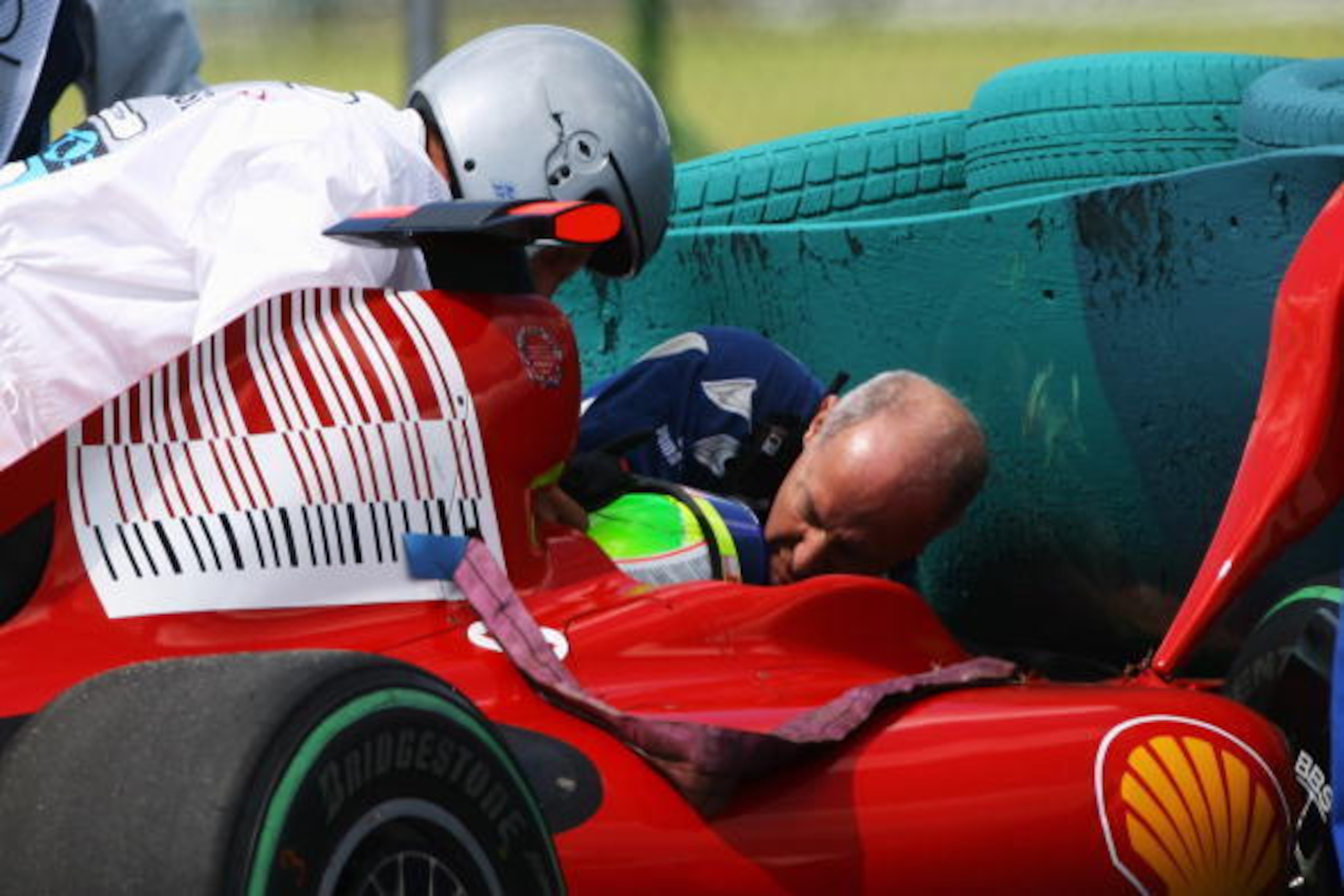 BUDAPEST, HUNGARY - JULY 25:  Felipe Massa of Brazil and Ferrari is attended to by F.I.A. doctor Gary Hartstein, medical staff and marshalls following his accident during qualifying for the Hungarian Formula One Grand Prix at the Hungaroring on July 25, 2