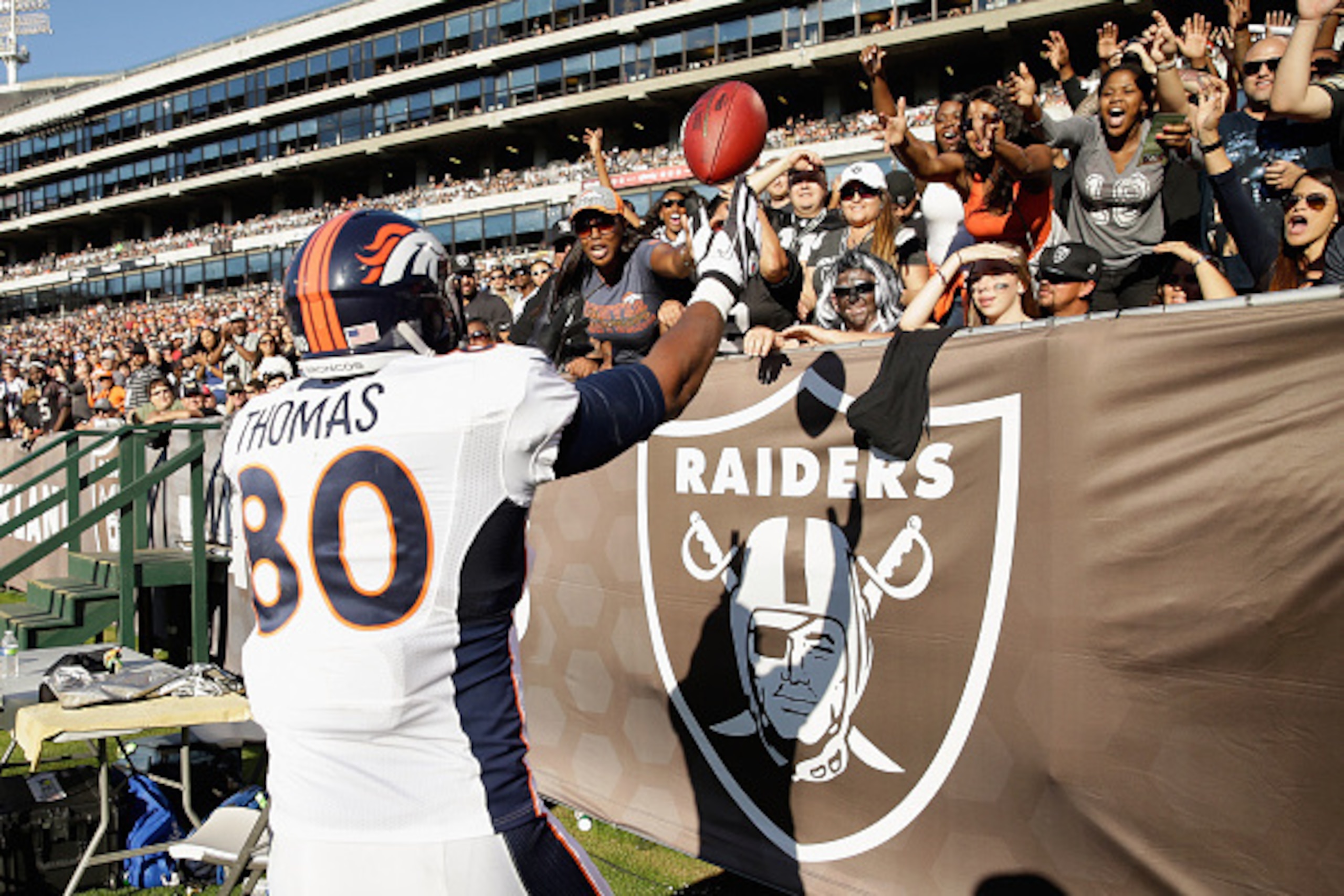 OAKLAND, CA - NOVEMBER 09:  Julius Thomas #80 of the Denver Broncos tosses the football to fans after his third-quarter touchdown against the Oakland Raiders at O.co Coliseum on November 9, 2014 in Oakland, California.  (Photo by Ezra Shaw/Getty Images)