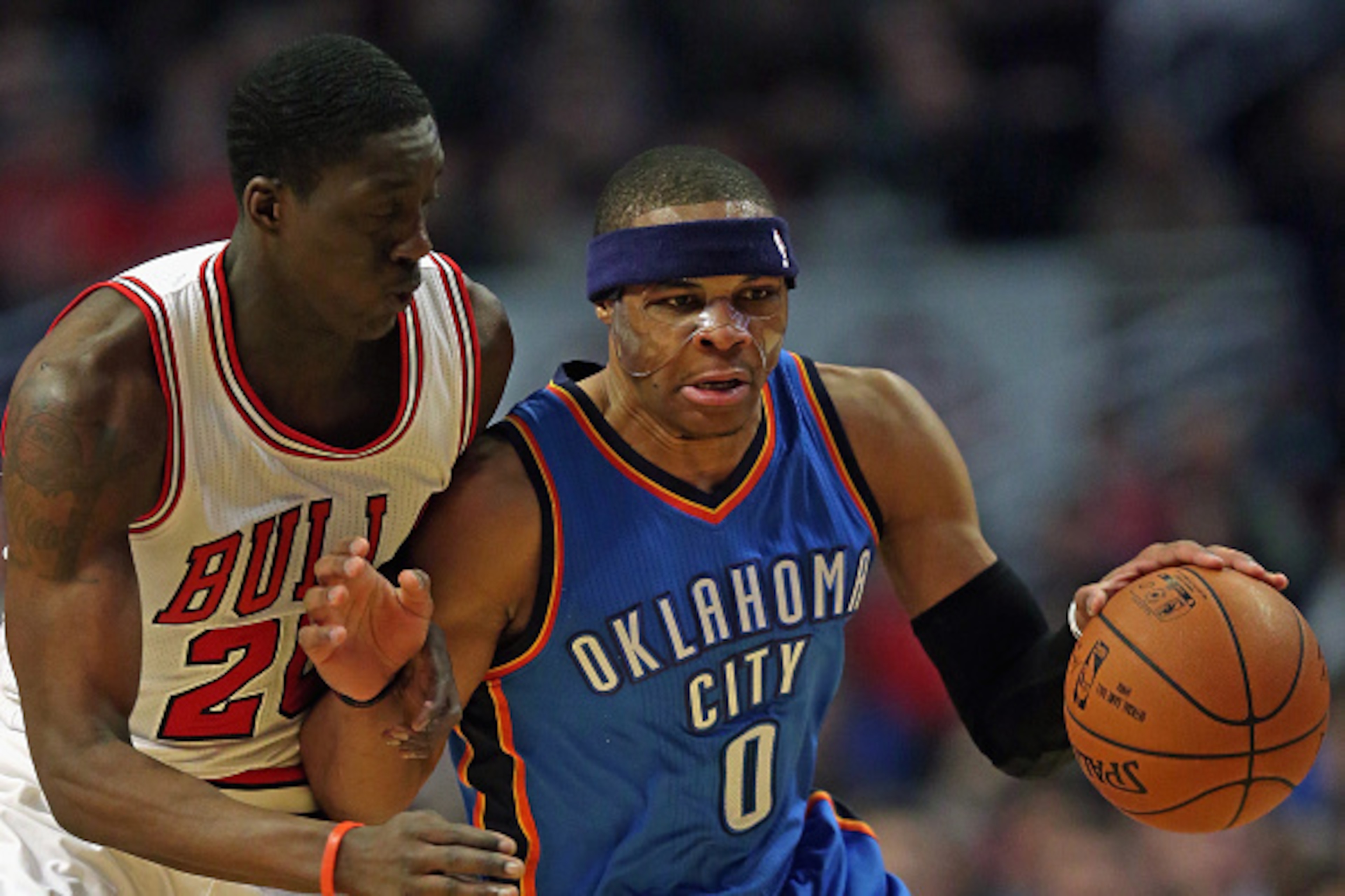 CHICAGO, IL - MARCH 05: Russell Westbrook #0 of the Oklahoma City Thunder is fouled by Tony Snell #20 of the Chicago Bulls at the United Center on March 5, 2015 in Chicago, Illinois. NOTE TO USER: User expressly acknowledges and agrees that, by downloadin