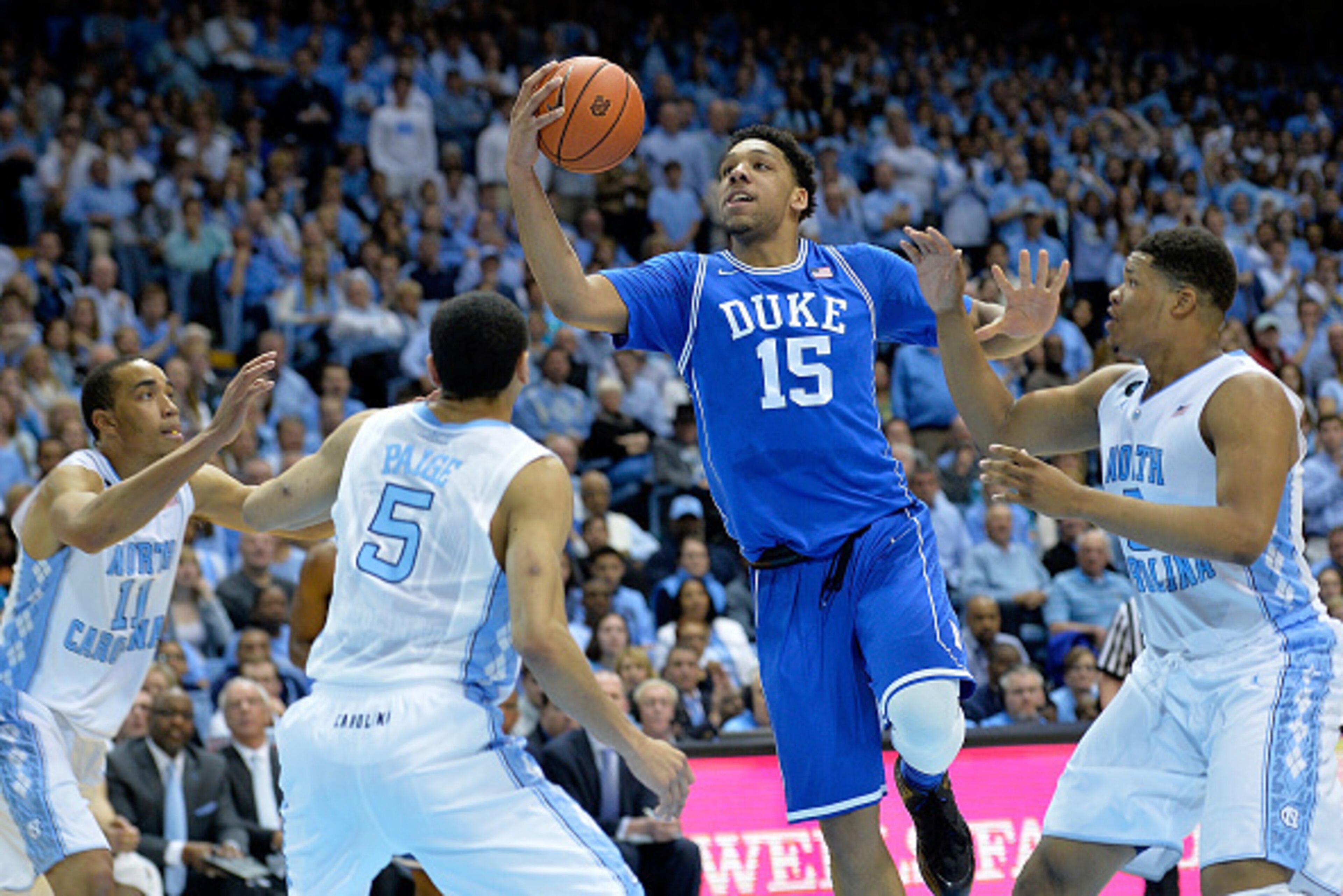 CHAPEL HILL, NC - MARCH 07:  Jahlil Okafor #15 of the Duke Blue Devil drives between defenders Brice Johnson #11, Marcus Paige #5 and Marcus Paige #5 of the North Carolina Tar Heels during their game at the Dean Smith Center on March 7, 2015 in Chapel Hil