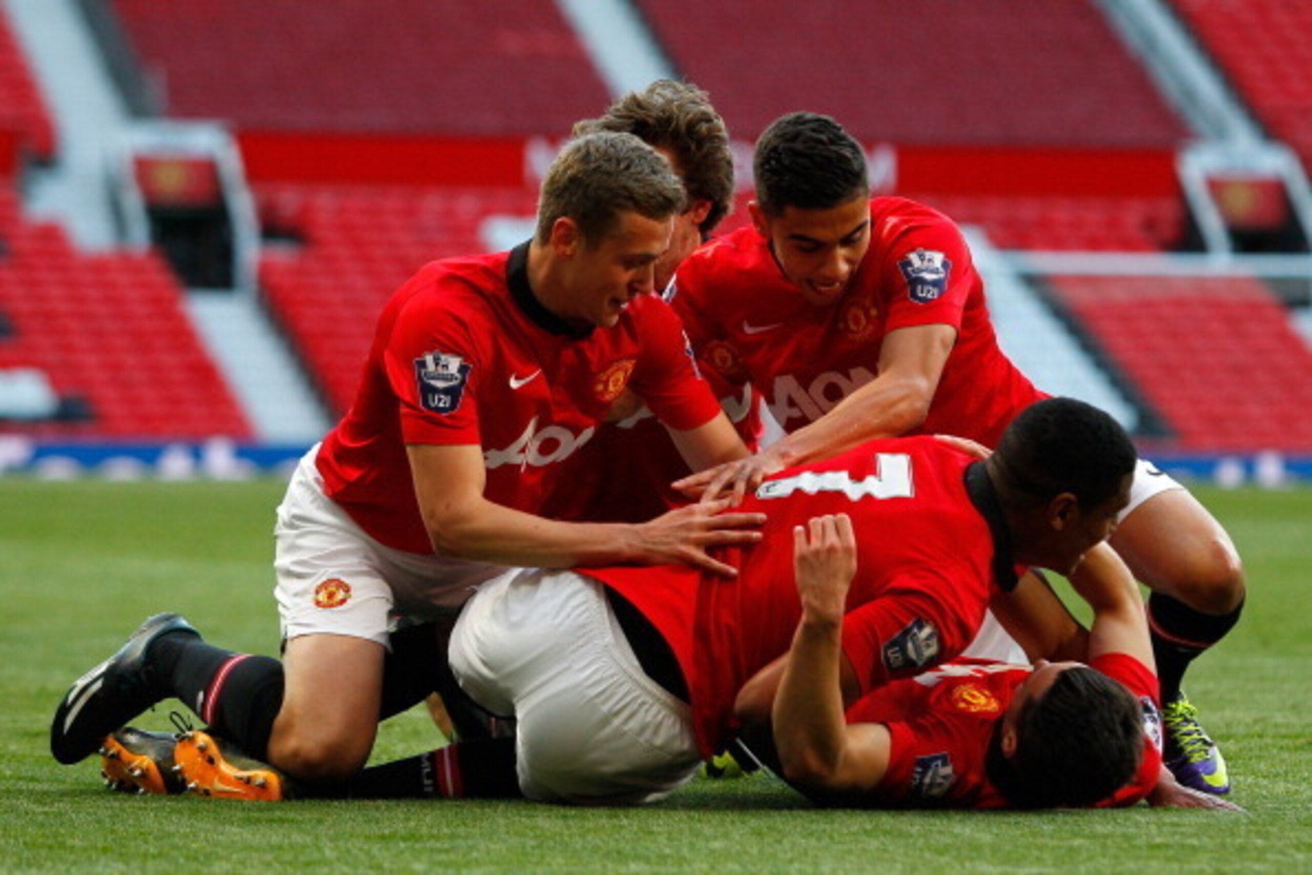 MANCHESTER, ENGLAND - MAY 14: Tom Lawrence of Manchester United celebrates his goal with team mates during the Barclays Under-21 Premier League Final match between Manchester United and Chelsea at Old Trafford on May 14, 2014 in Manchester, England. (Phot MANCHESTER, ENGLAND - MAY 14: Tom Lawrence of Manchester United celebrates his goal with team mates during the Barclays Under-21 Premier League Final match between Manchester United and Chelsea at Old Trafford on May 14, 2014 in Manchester, England. (Phot