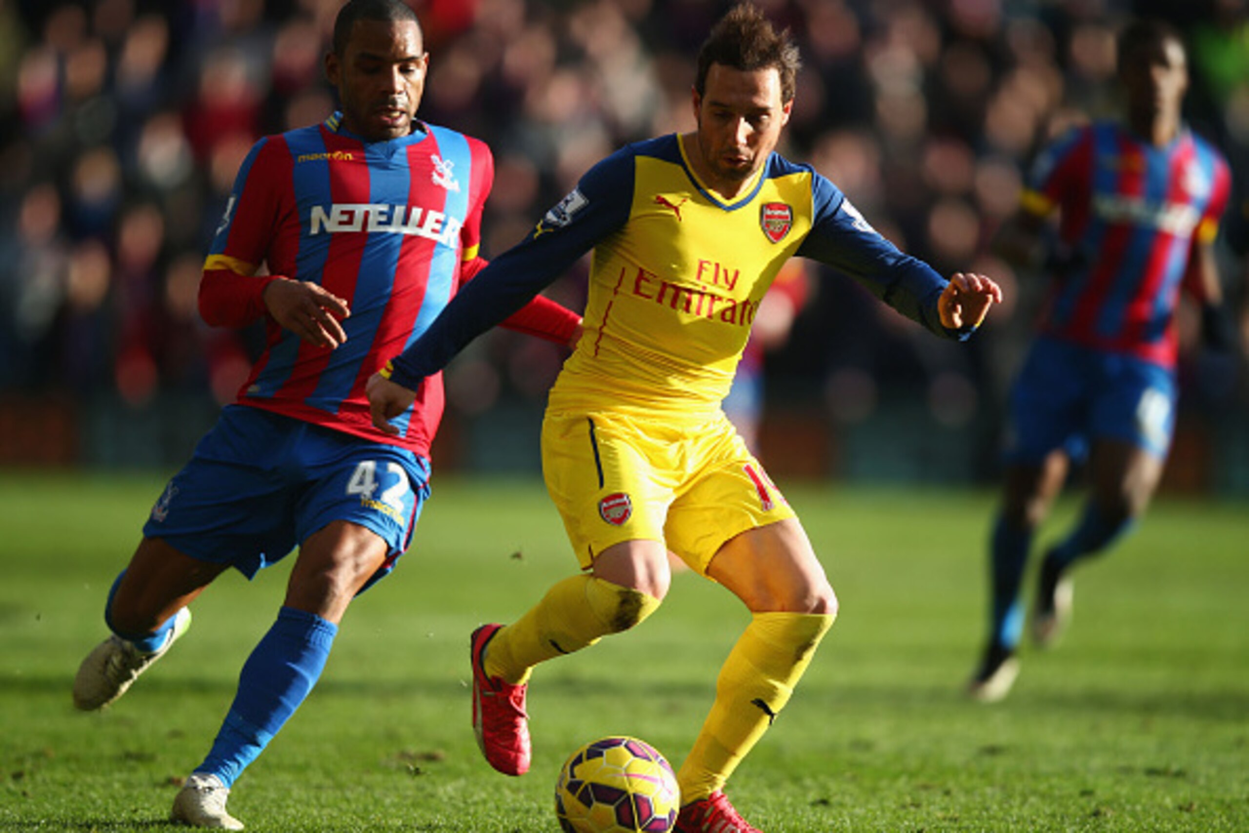 LONDON, ENGLAND - FEBRUARY 21:  Santi Cazorla of Arsenal shields the ball from Jason Puncheon of Crystal Palace during the Barclays Premier League match between Crystal Palace and Arsenal at Selhurst Park on February 21, 2015 in London, England.  (Photo b