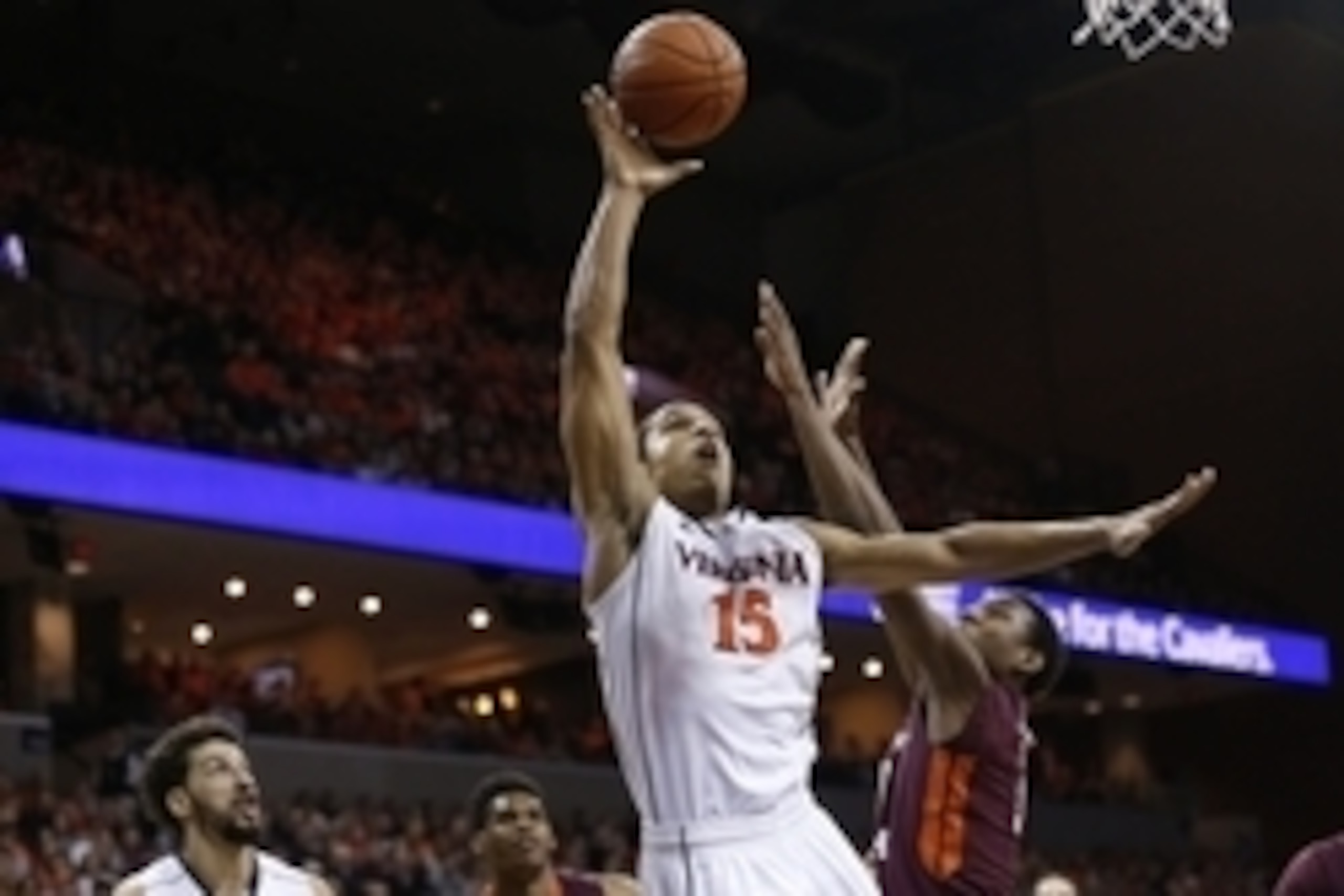 Feb 28, 2015; Charlottesville, VA, USA; Virginia Cavaliers guard Malcolm Brogdon (15) shoots the ball as Virginia Tech Hokies guard Justin Bibbs (10) defends in the second half at John Paul Jones Arena. The Cavaliers won 69-57. Mandatory Credit: Geoff Bur