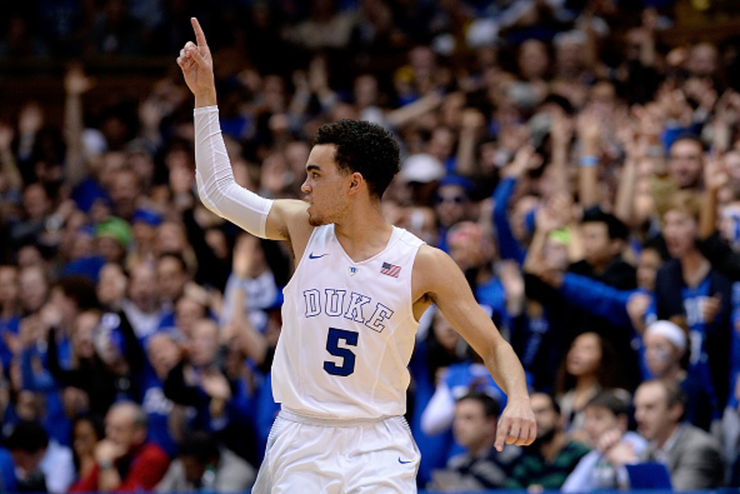 DURHAM, NC - FEBRUARY 28:  Tyus Jones #5 of the Duke Blue Devils reacts after making a three-point basket against the Syracuse Orange during their game at Cameron Indoor Stadium on February 28, 2015 in Durham, North Carolina. Duke won 73-54.  (Photo by Gr