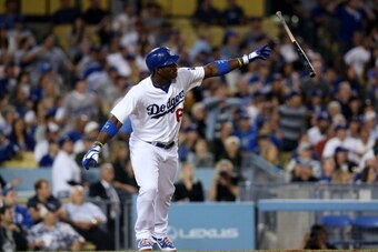 LOS ANGELES, CA - SEPTEMBER 12:  Yasiel Puig #66 of the Los Angeles Dodgers throws his bat as he watches his RBI double  to break a 1-1 tie in the seventh inning against the San Francisco Giants at Dodger Stadium on September 12, 2013 in Los Angeles, Cali