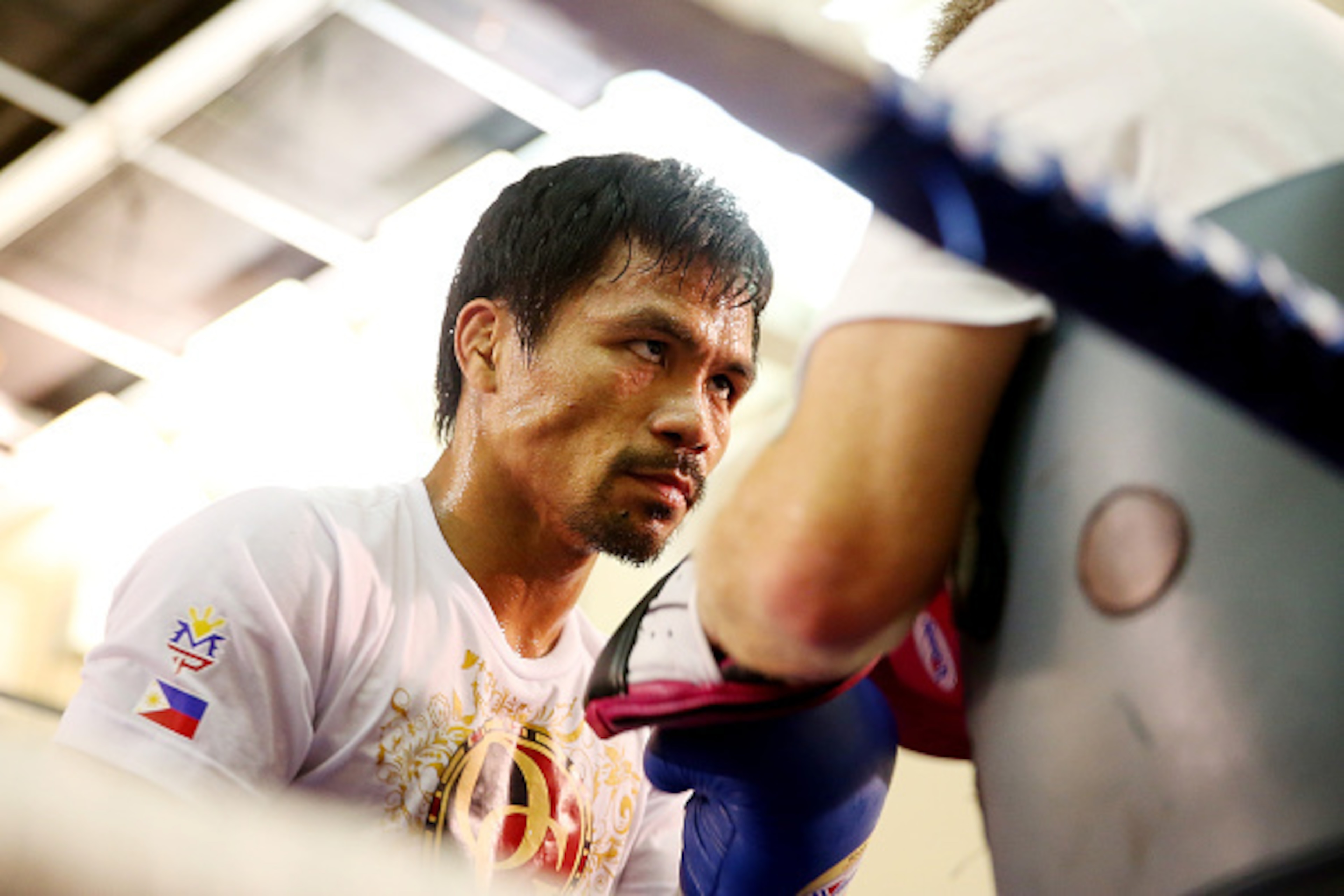 MACAU - NOVEMBER 20:  Manny Pacquiao works the mitts with trainer Freddie Roach during a workout session at The Venetian on November 20, 2014 in Macau, Macau.  (Photo by Chris Hyde/Getty Images)