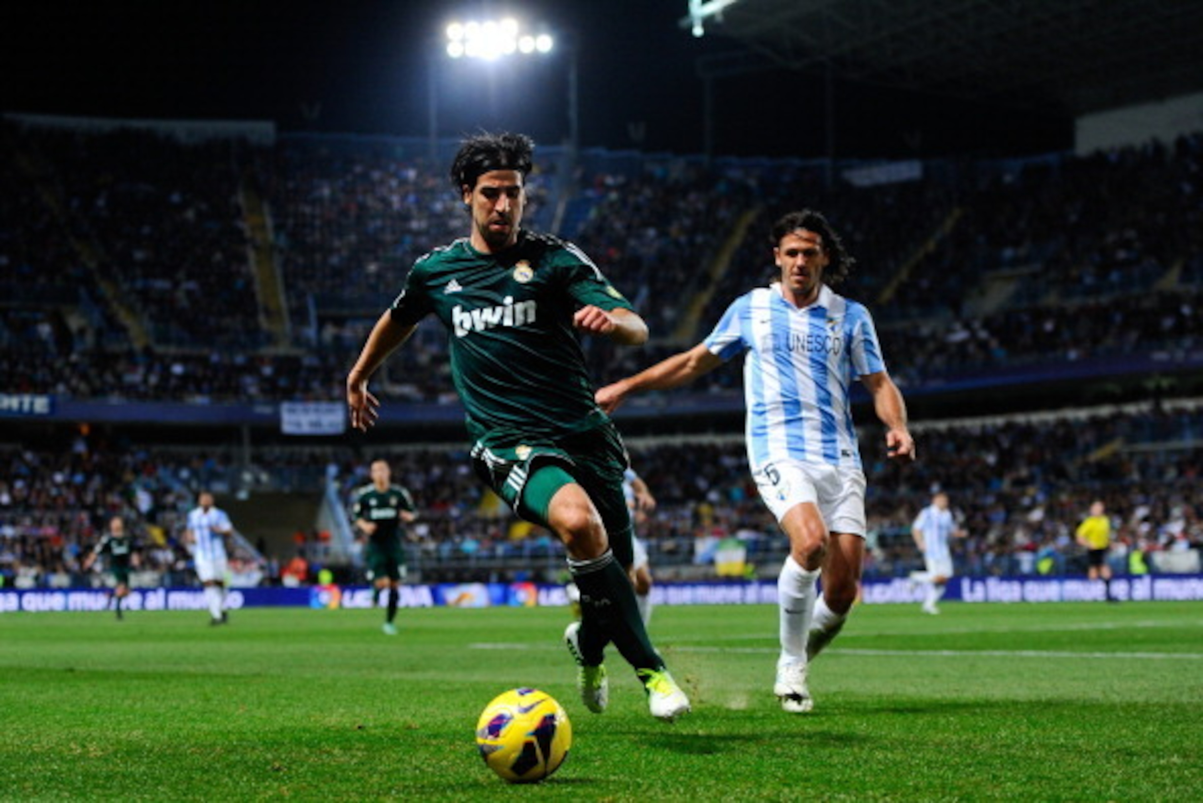 MALAGA, SPAIN - DECEMBER 22:  Sami Khedira of Real Madrid CF duels for the ball with Martin Gaston Demichelis of Malaga CF during the La Liga match between Malaga CF and Real Madrid CF at La Rosaleda Stadium on December 22, 2012 in Malaga, Spain.  (Photo 