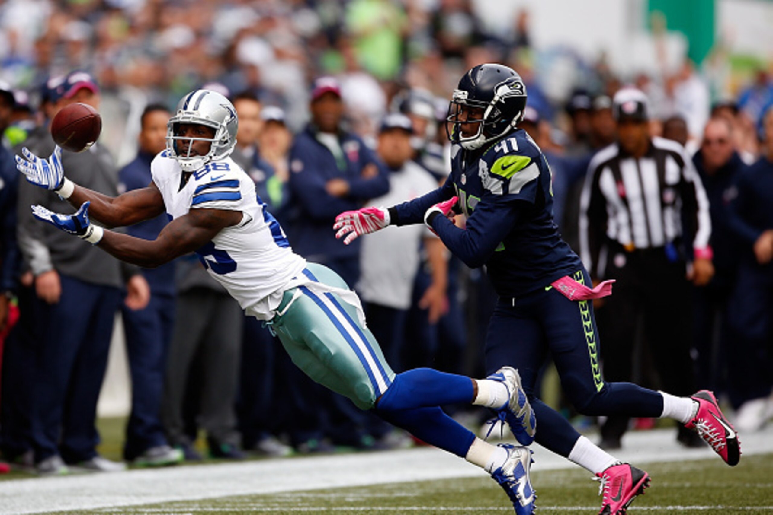 SEATTLE, WA - OCTOBER 12: Wide receiver Dez Bryant #88 of the Dallas Cowboys catches a pass against cornerback Byron Maxwell #41 of the Seattle Seahawks during the first quarter of the game at CenturyLink Field on October 12, 2014 in Seattle, Washington. 