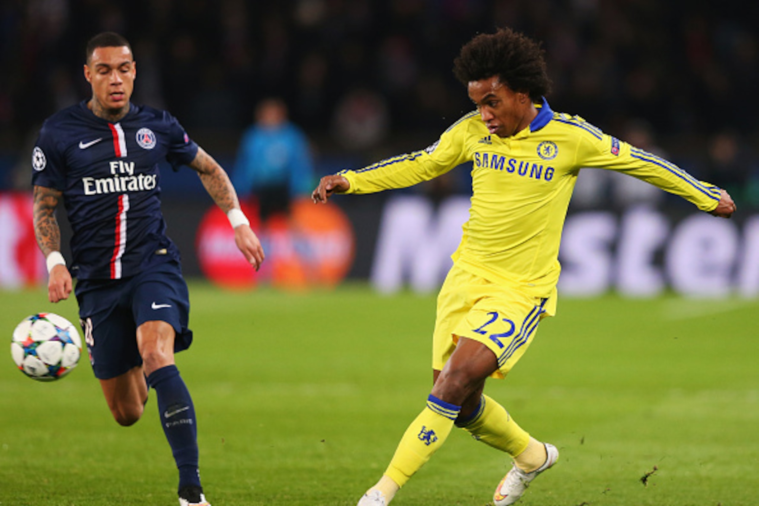 PARIS, FRANCE - FEBRUARY 17:  Willian of Chelsea beats Gregory van der Wiel of Paris Saint-Germain to the ball during the UEFA Champions League Round of 16 match between Paris Saint-Germain and Chelsea at Parc des Princes on February 17, 2015 in Paris, Fr