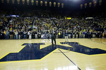 ANN ARBOR, MI - DECEMBER 30:  Jim Harbaugh addresses the crowd at Crisler Arena during halftime of the Michigan Wolverines basketball game against the Illinois Fighting Illini after being announced as the new football coach at a news conference earlier in